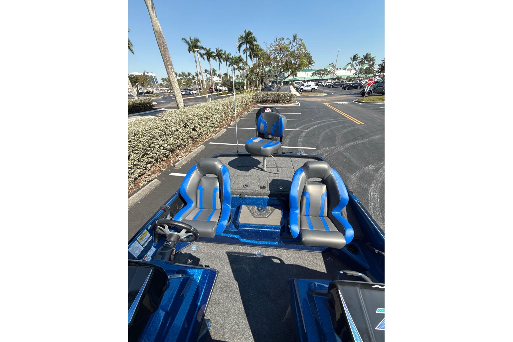 2026 Nitro Z19 XL boat with blue and gray seats in a parking lot.