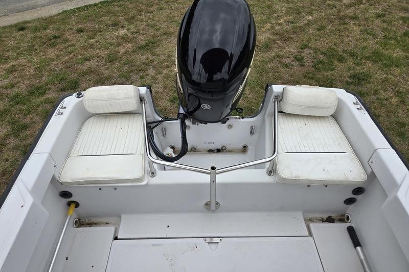 1996 Boston Whaler Outrage 17 boat interior with motor and seating.