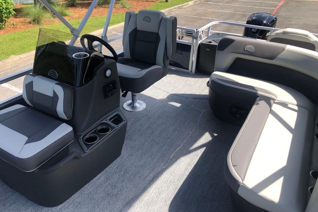 2026 Sun Tracker Bass Buggy 18 DLX pontoon boat interior with seating and steering console.