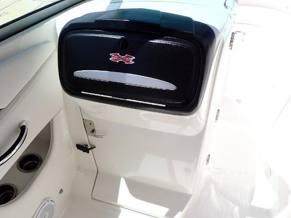 2011 Chaparral 287 SSX boat interior with storage compartment and cup holders.