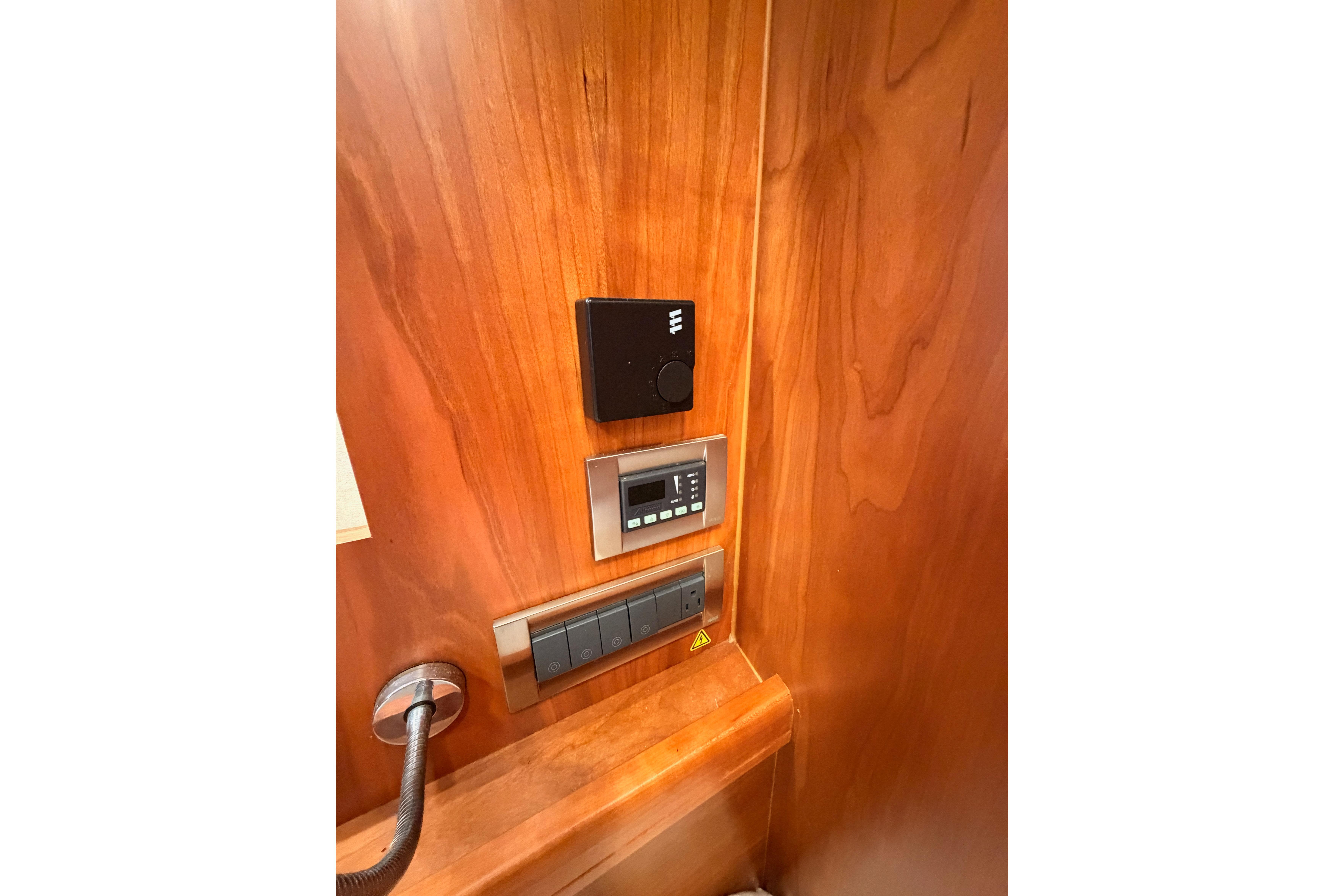 Control panel on wooden interior of 2016 Moody Decksaloon 54 yacht.