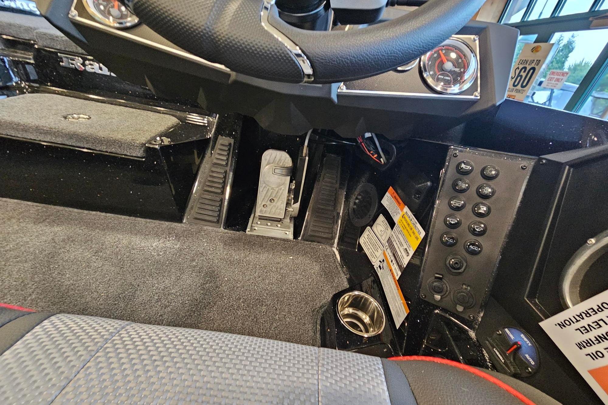 Interior of 2026 Ranger Z518 Cup-Equipped boat, featuring steering wheel and control panel.