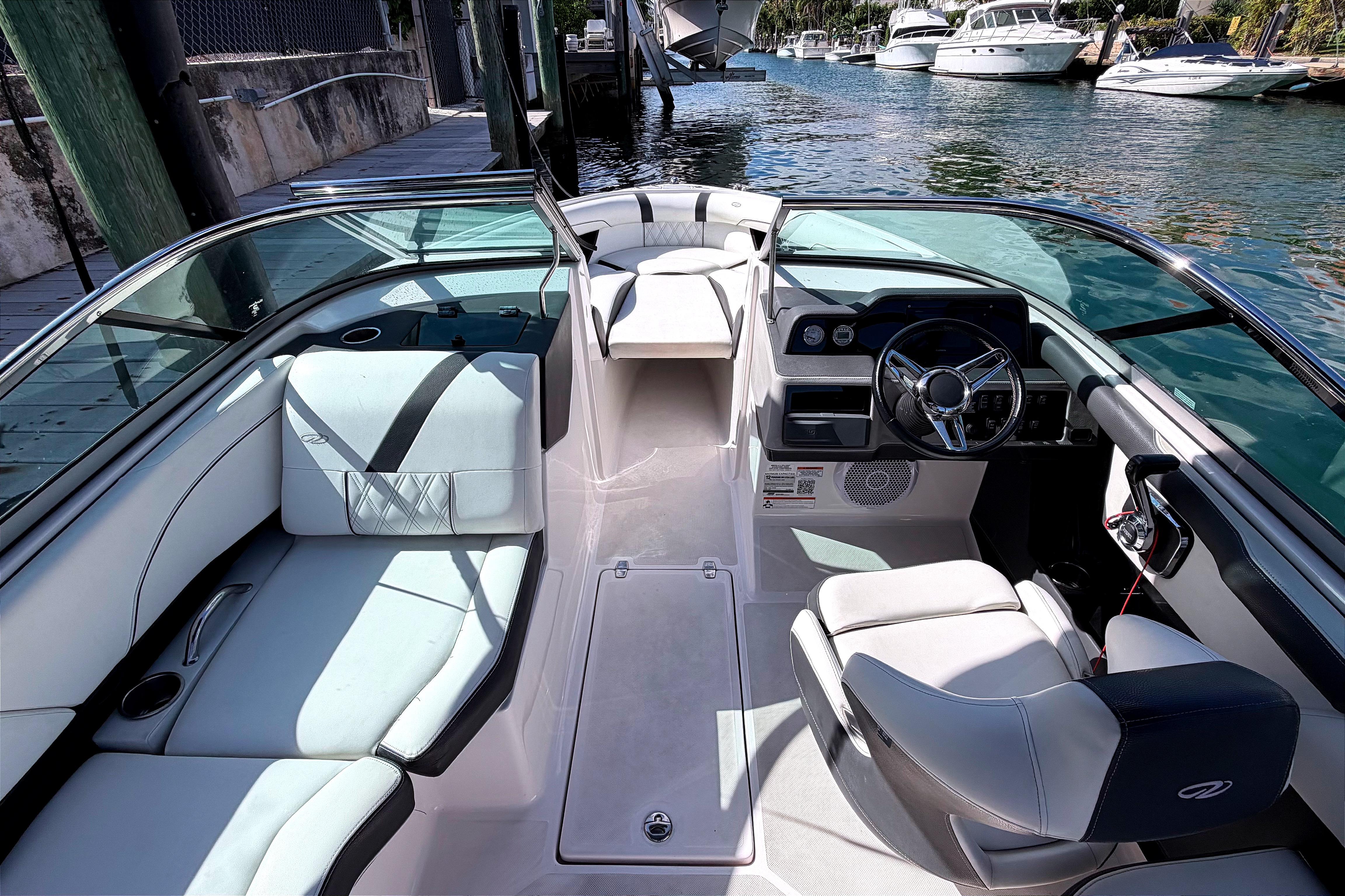2020 Regal 2300 Bowrider interior with sleek seating and modern dashboard on a sunny day.