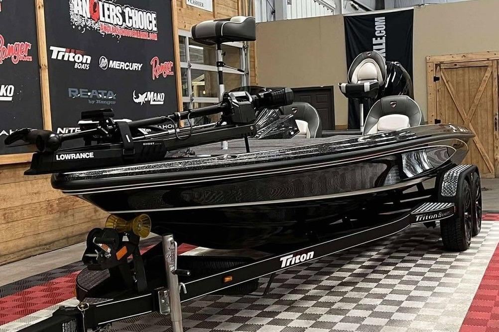 2026 Triton 20XP Patriot boat in showroom, featuring Lowrance equipment.