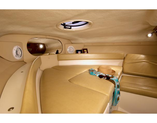 Interior of 2008 Regal 2250 Cuddy boat with beige seating.