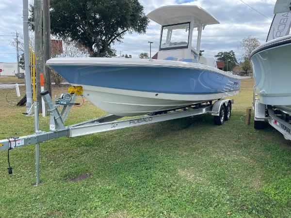 2026 Robalo 246 Cayman boat on trailer, displayed outdoors.