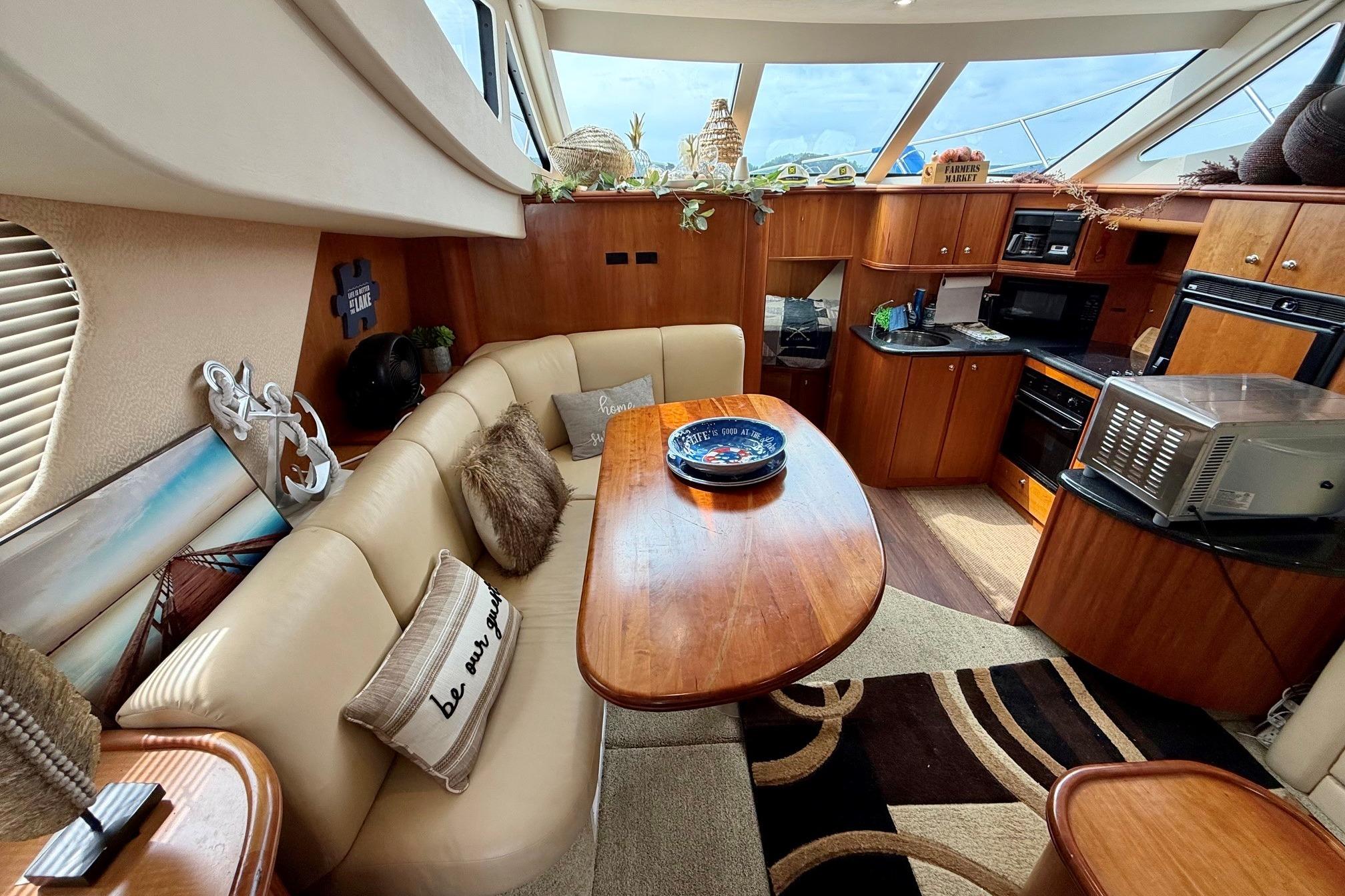 Luxurious interior of 2004 Silverton 39 Motor Yacht with elegant dining and kitchen area.