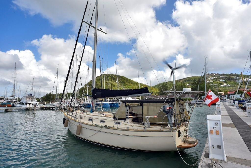 1992 Island Packet 38 sailboat docked in a marina, surrounded by other boats.