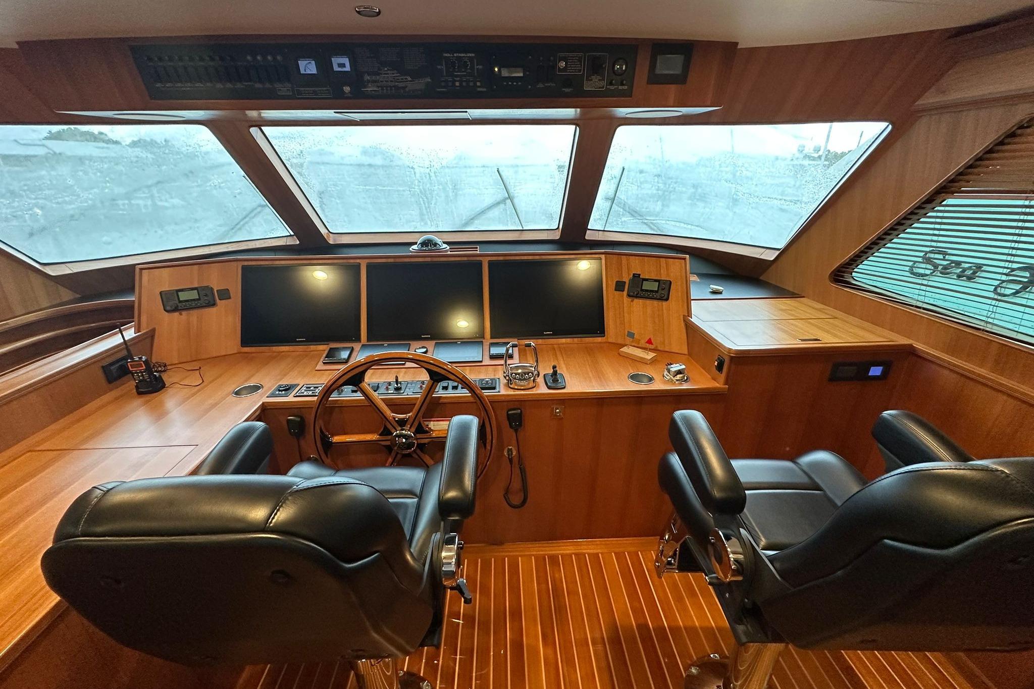 2023 Marlow Explorer 66E-CB helm with dual leather chairs and advanced navigation systems.