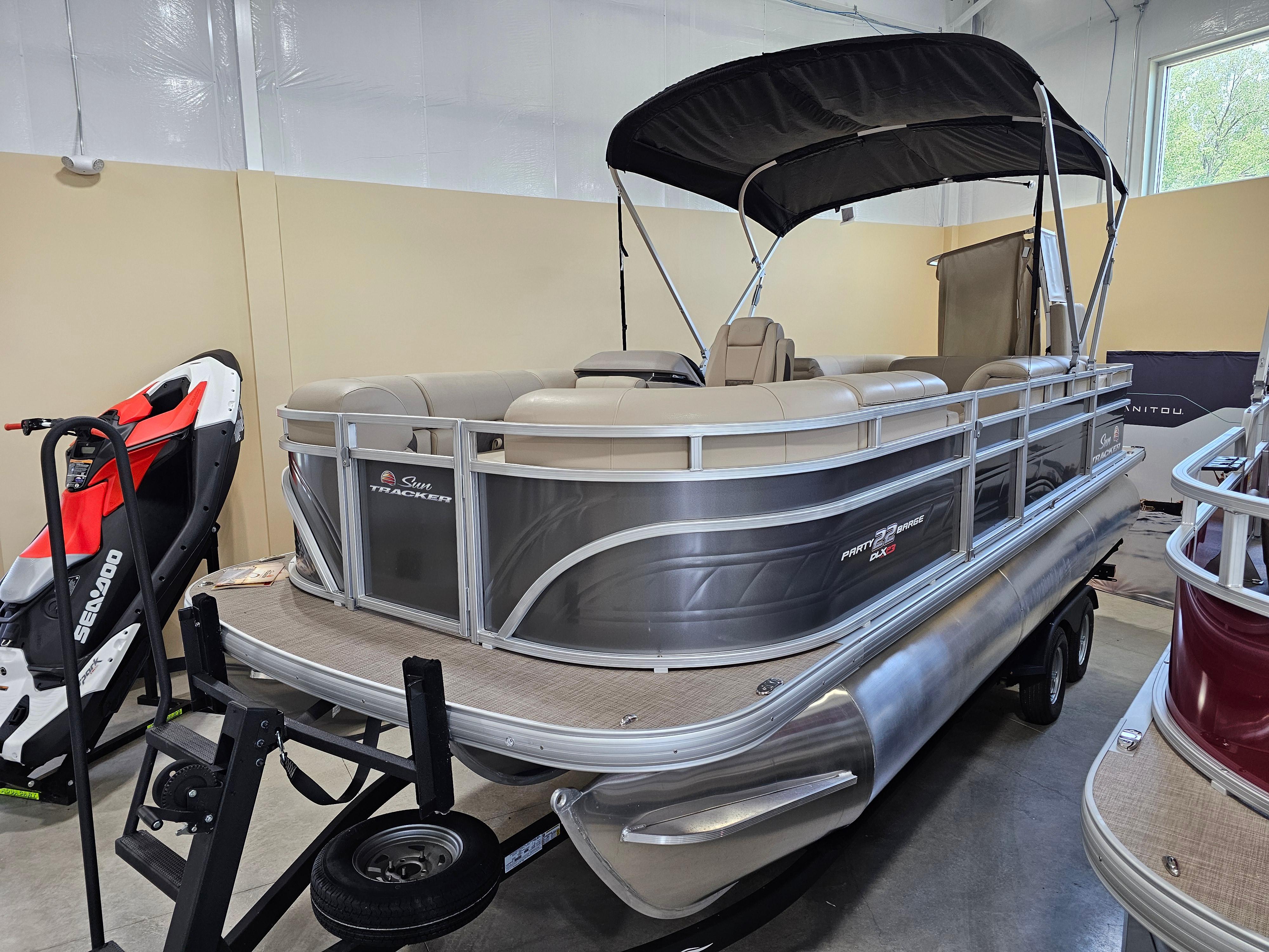 2024 Sun Tracker Party Barge 22 RF XP3 pontoon boat displayed indoors.