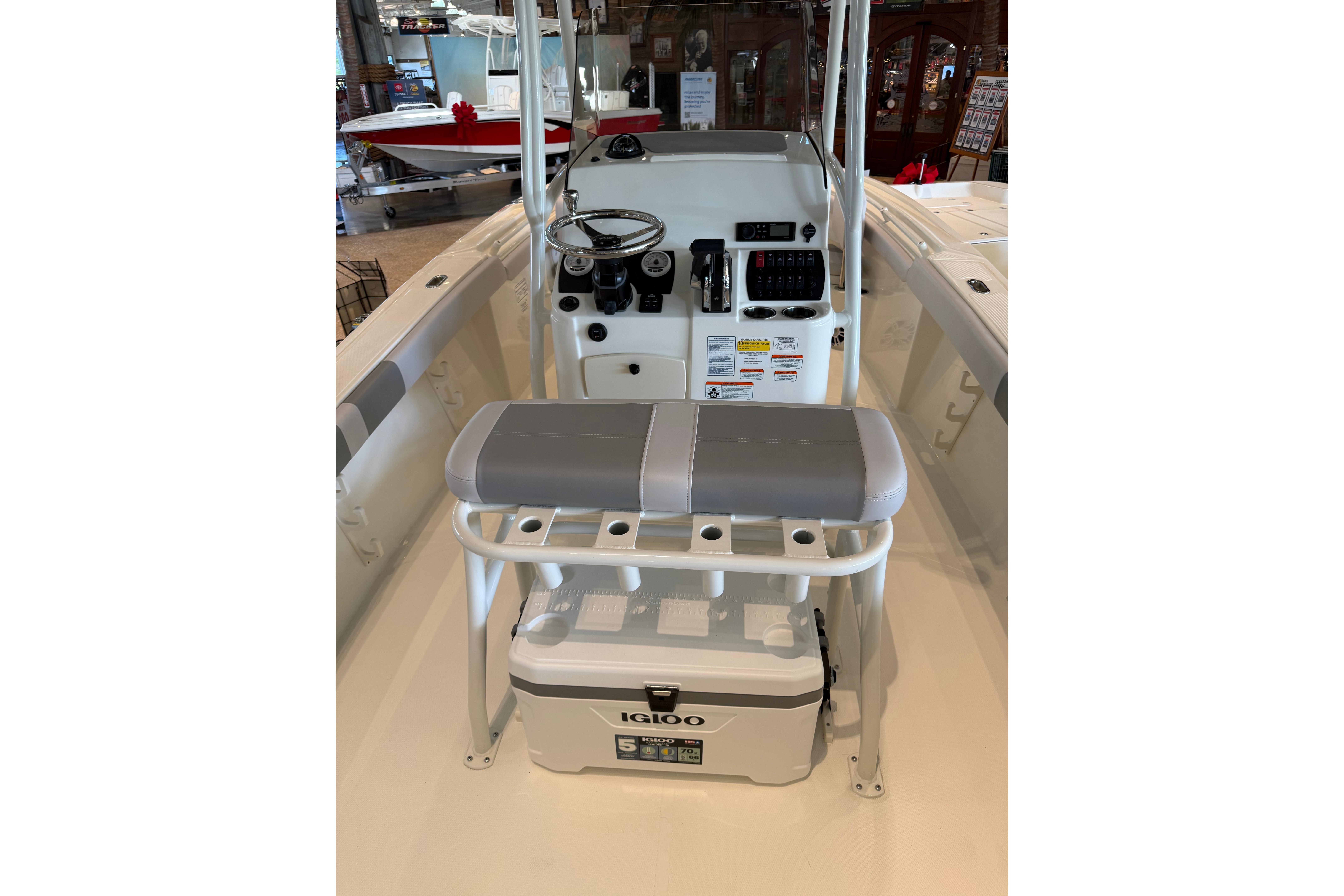 2026 Mako 214 Center Console boat interior with steering wheel and seating.