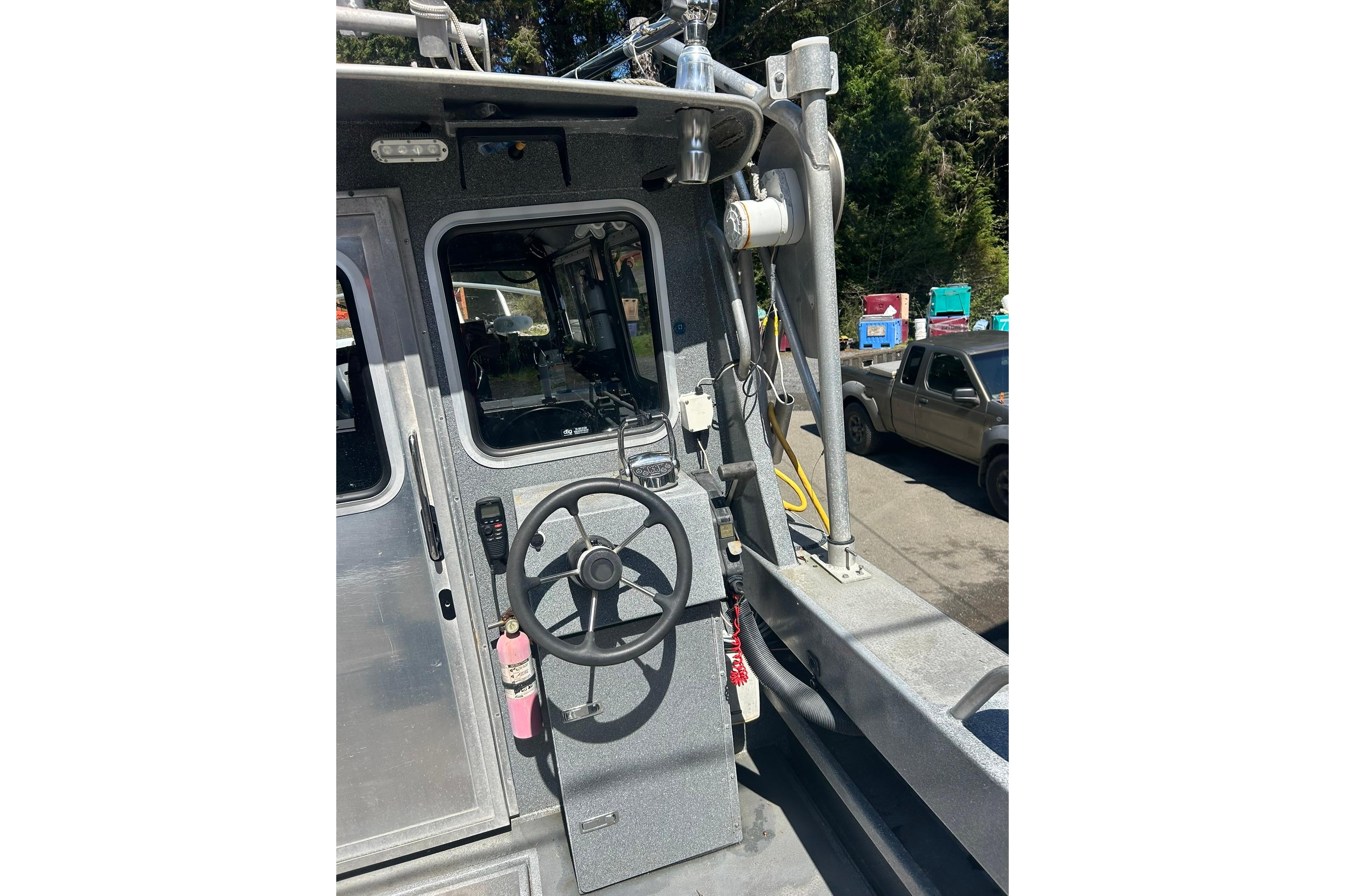 2016 North River 29 Offshore boat helm with steering wheel and controls.
