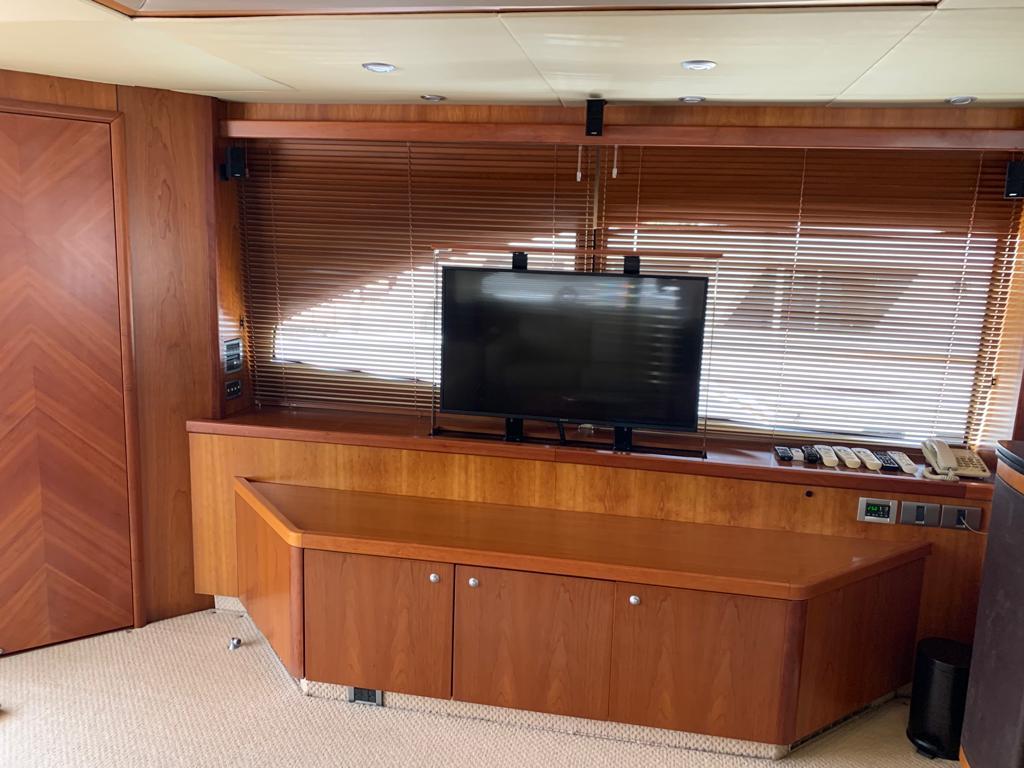 Interior of 2006 Sunseeker 90 Yacht with wooden cabinetry and mounted TV.
