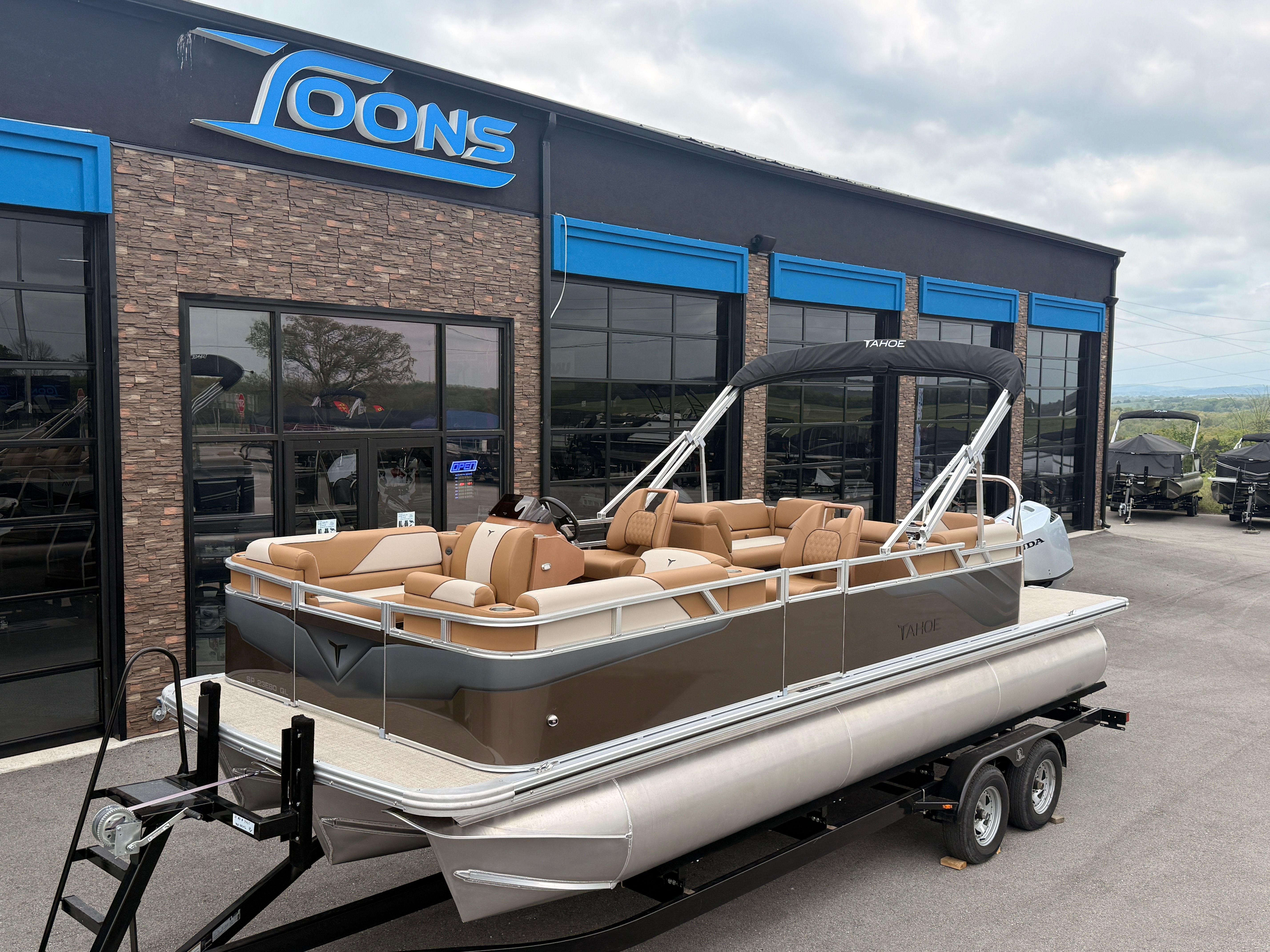 2026 Tahoe 2380 Sport Quad Lounger in front of showroom.