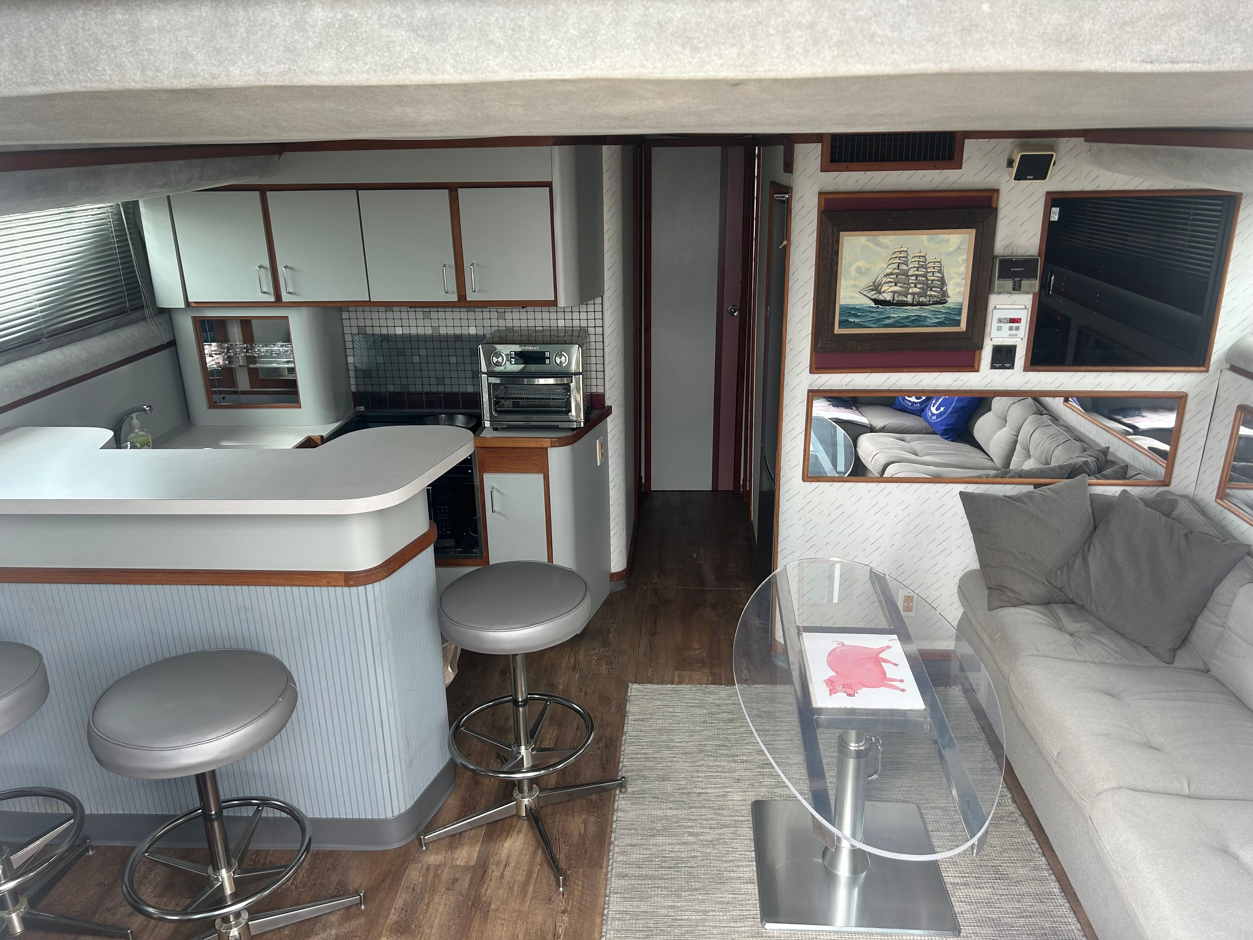 Interior of a 1988 Cruisers Yachts 4280 Express Bridge with bar, sofa, and artwork.