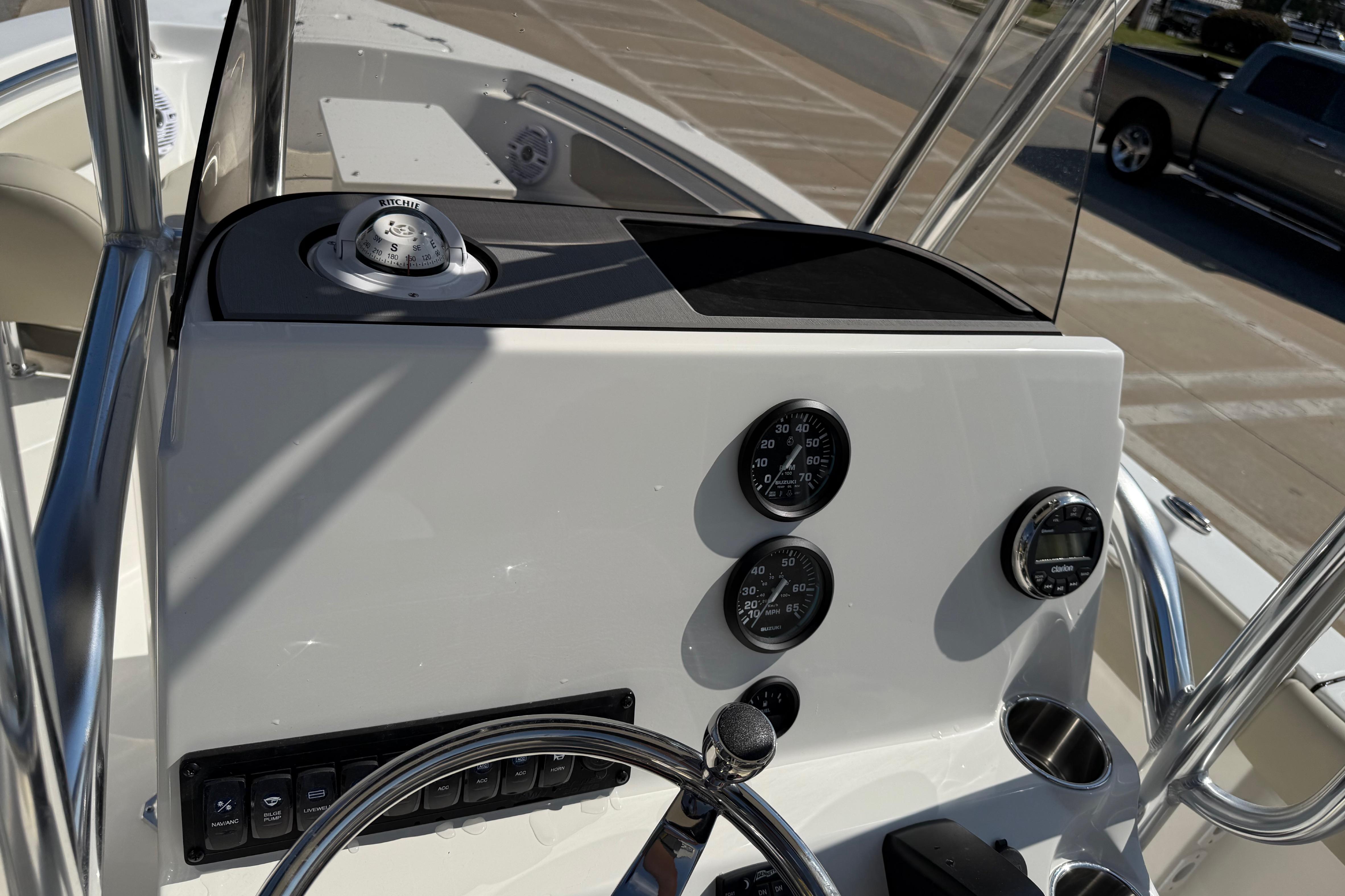 2026 Key West 203 FS boat dashboard with gauges and steering wheel.