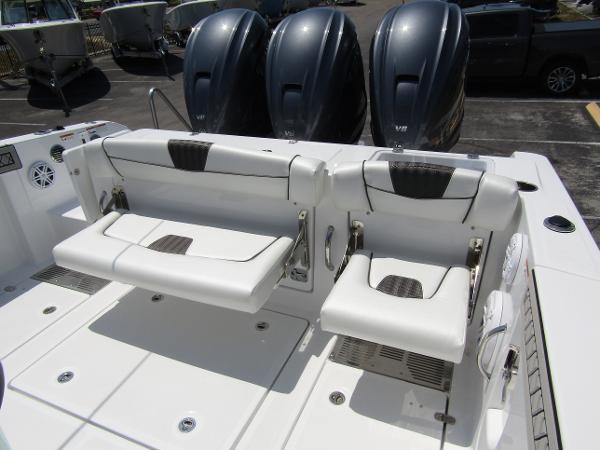 2024 Wellcraft 352 Fisherman boat with triple outboard engines and foldable seating.