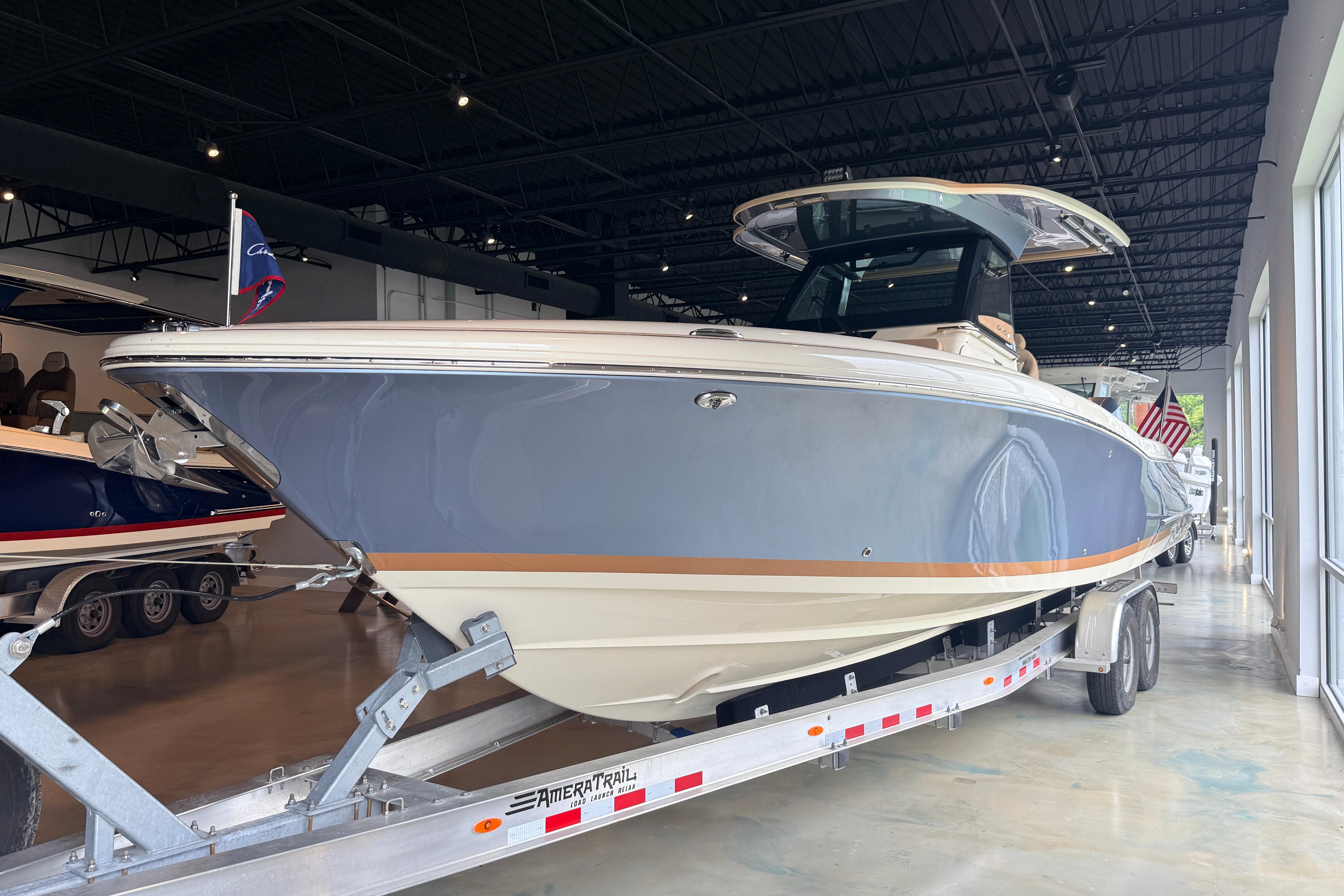 2024 Chris-Craft Catalina 30 boat on trailer in showroom.