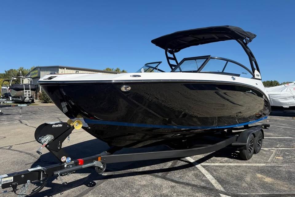 2026 Yamaha Boats 252SD on trailer, sleek black design under clear blue sky.