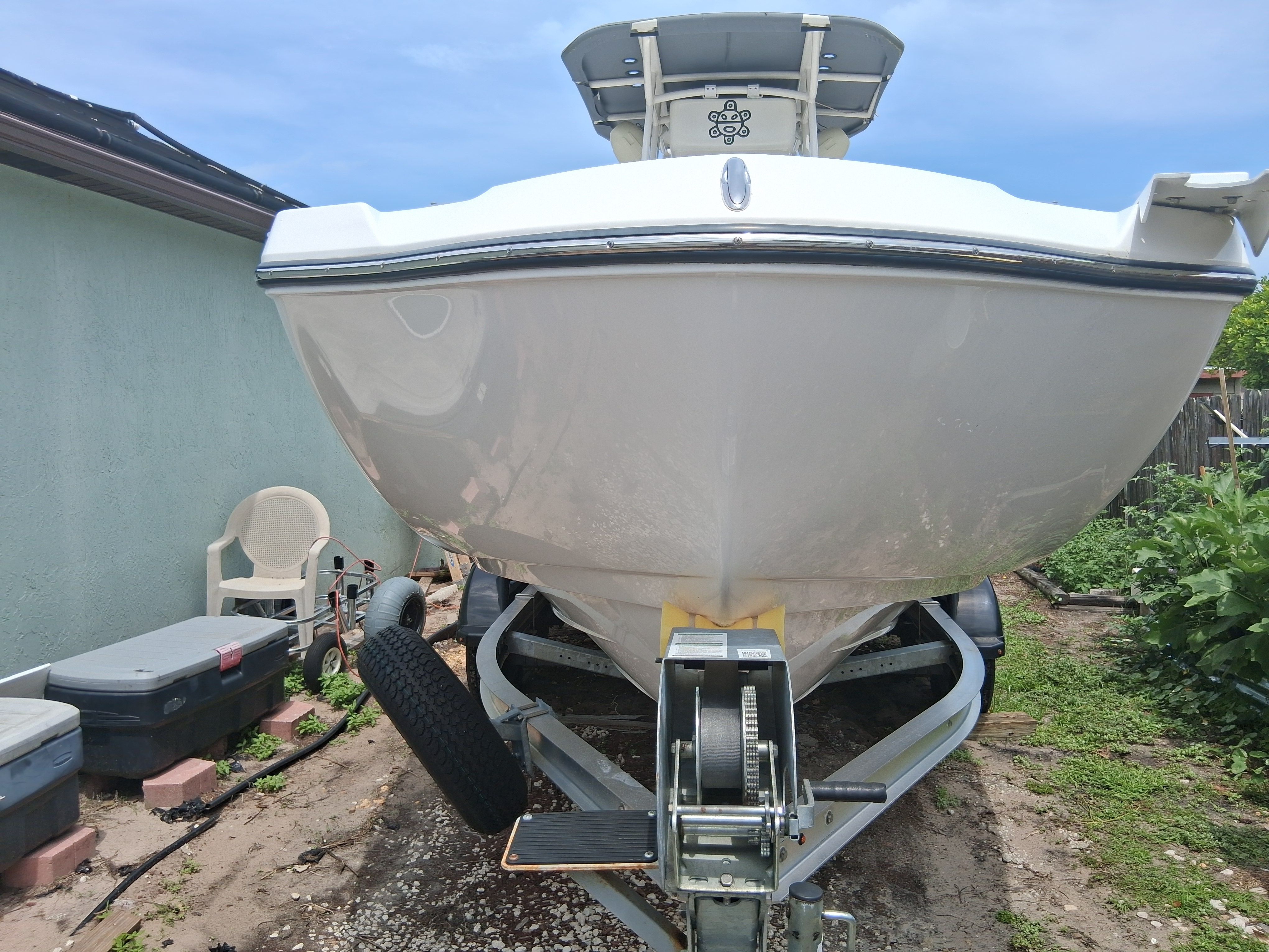A 2023 Yamaha 220 FSH Sport boat on a trailer outdoors.