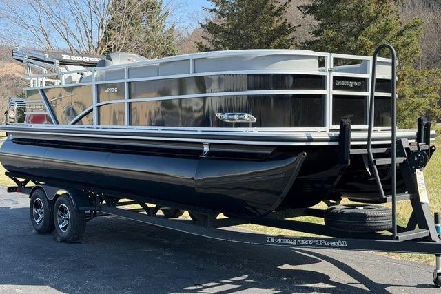 2025 Ranger Reata 223C pontoon boat on trailer, parked outdoors.