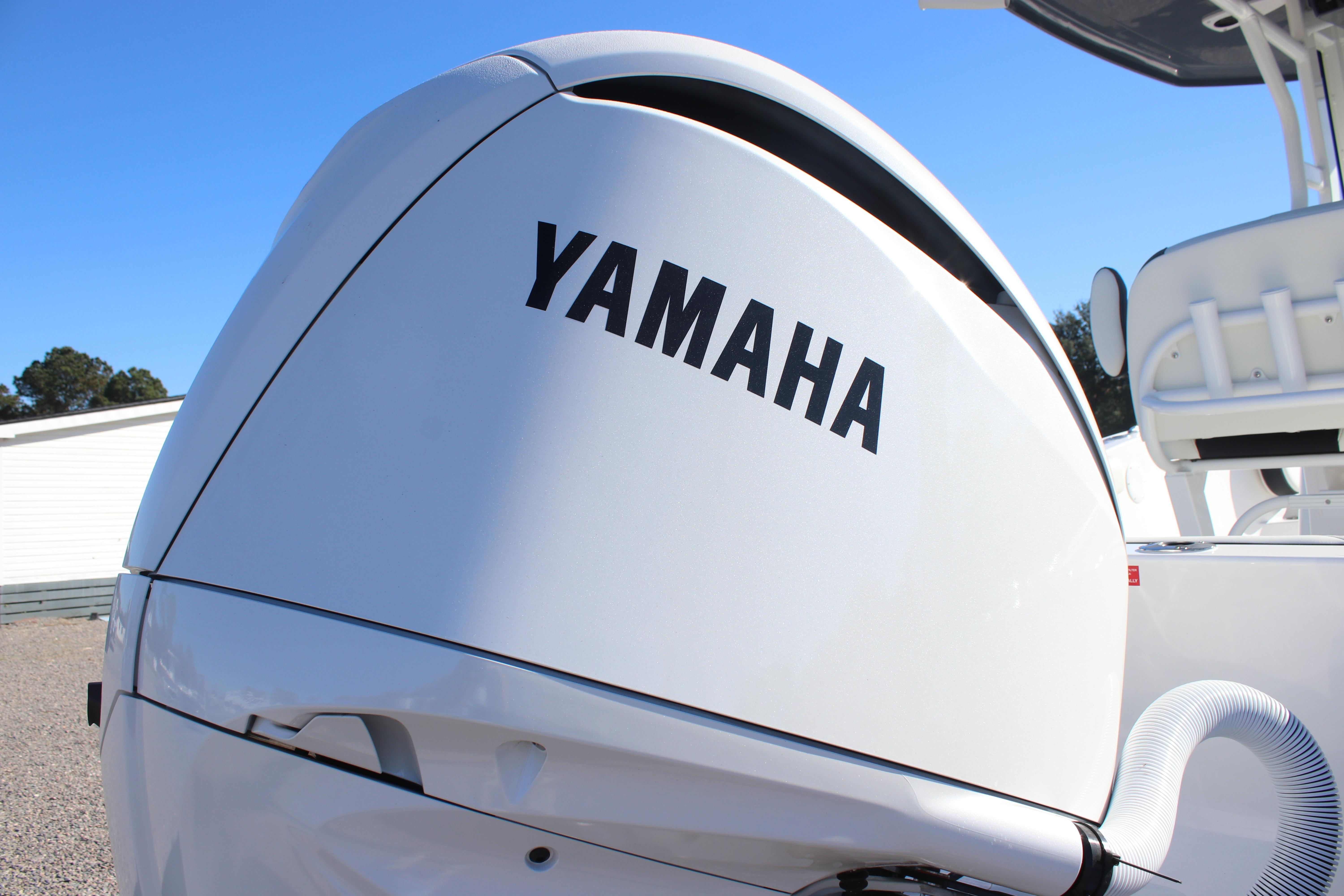 Yamaha engine on 2026 Tidewater 232 CC Adventure boat under clear blue sky.