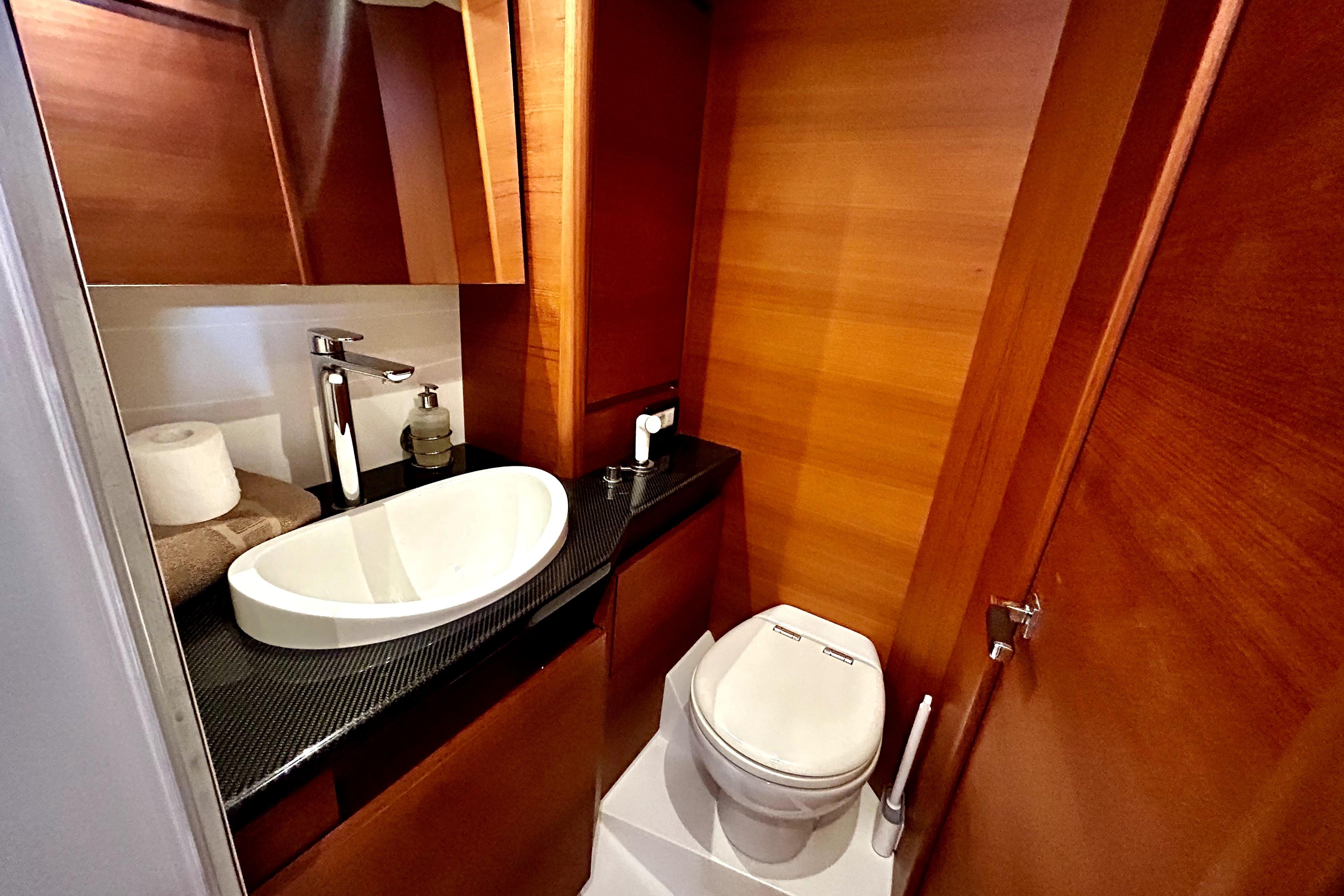 Luxurious bathroom in 2022 Solaris 55 yacht with modern sink and toilet.