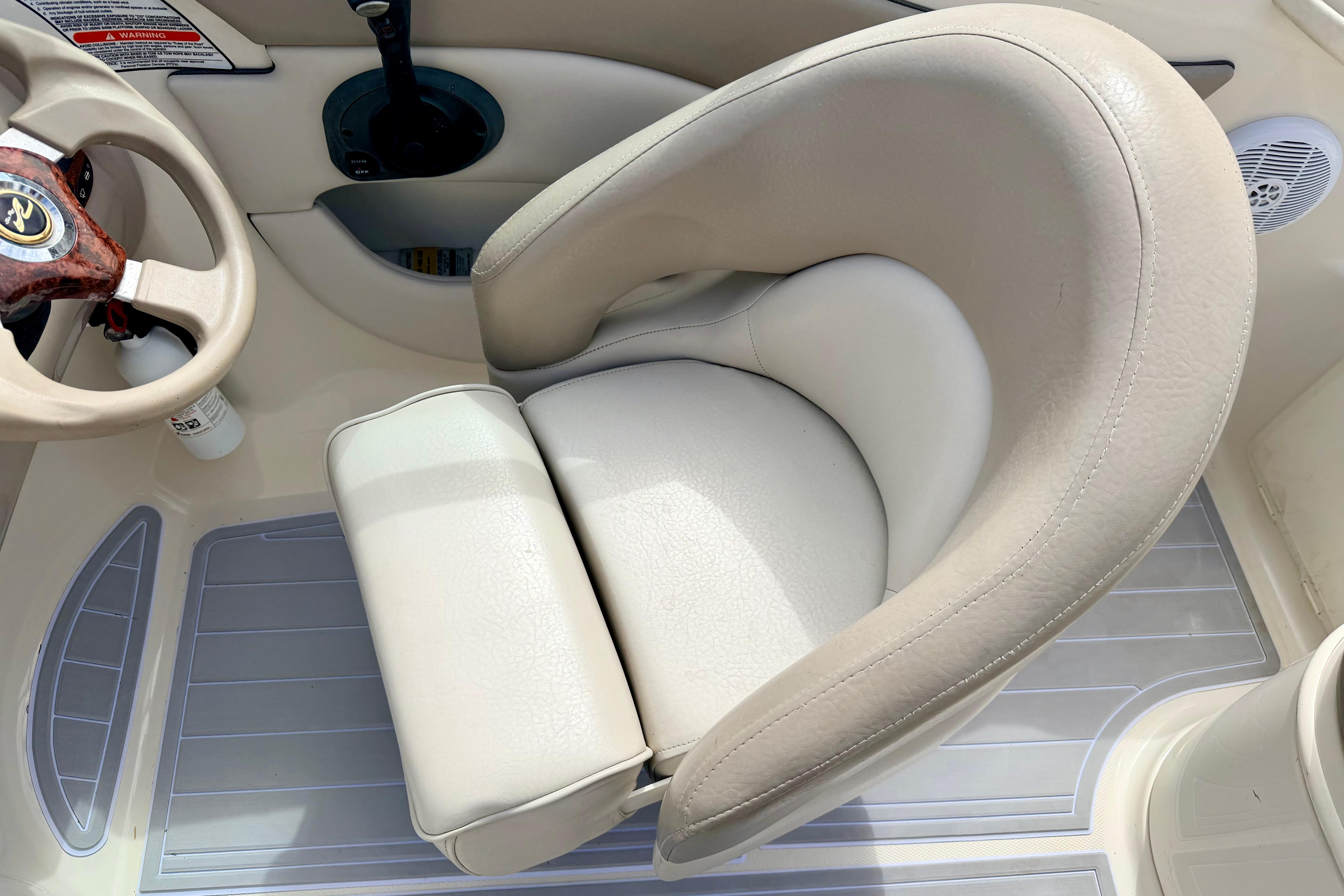 Captain's seat and steering wheel of 2003 Sea Ray 200 Sundeck boat.