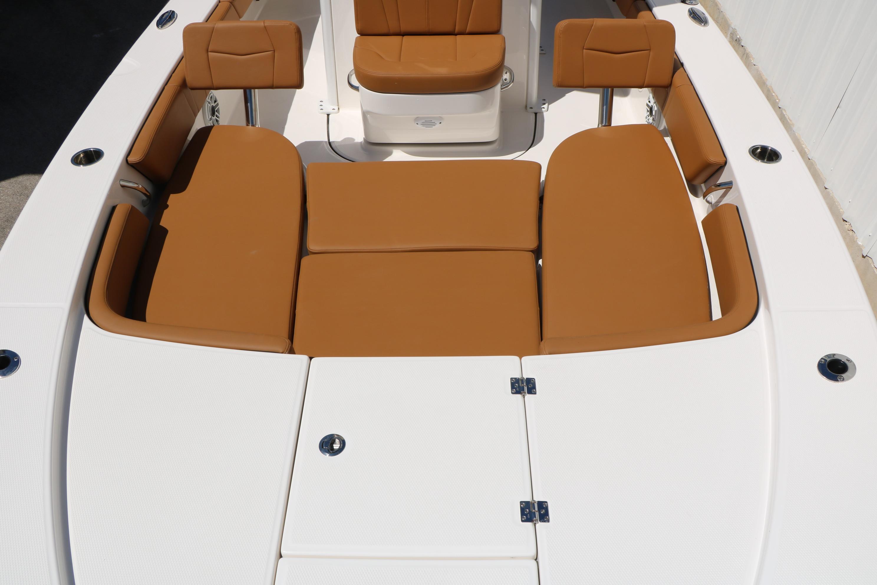 2026 Robalo 246 Cayman boat with tan cushioned seating and white deck.
