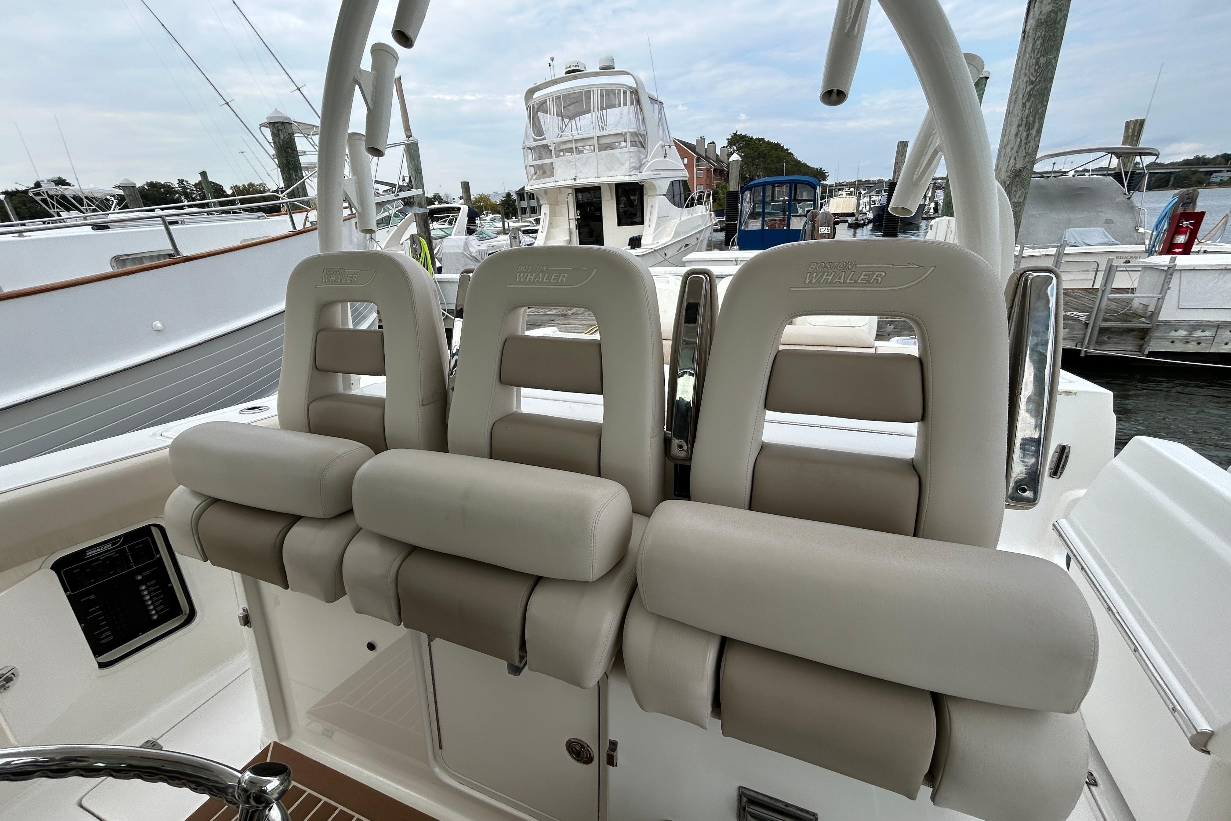 2017 Boston Whaler 370 Outrage boat seats at marina, showcasing luxury design.