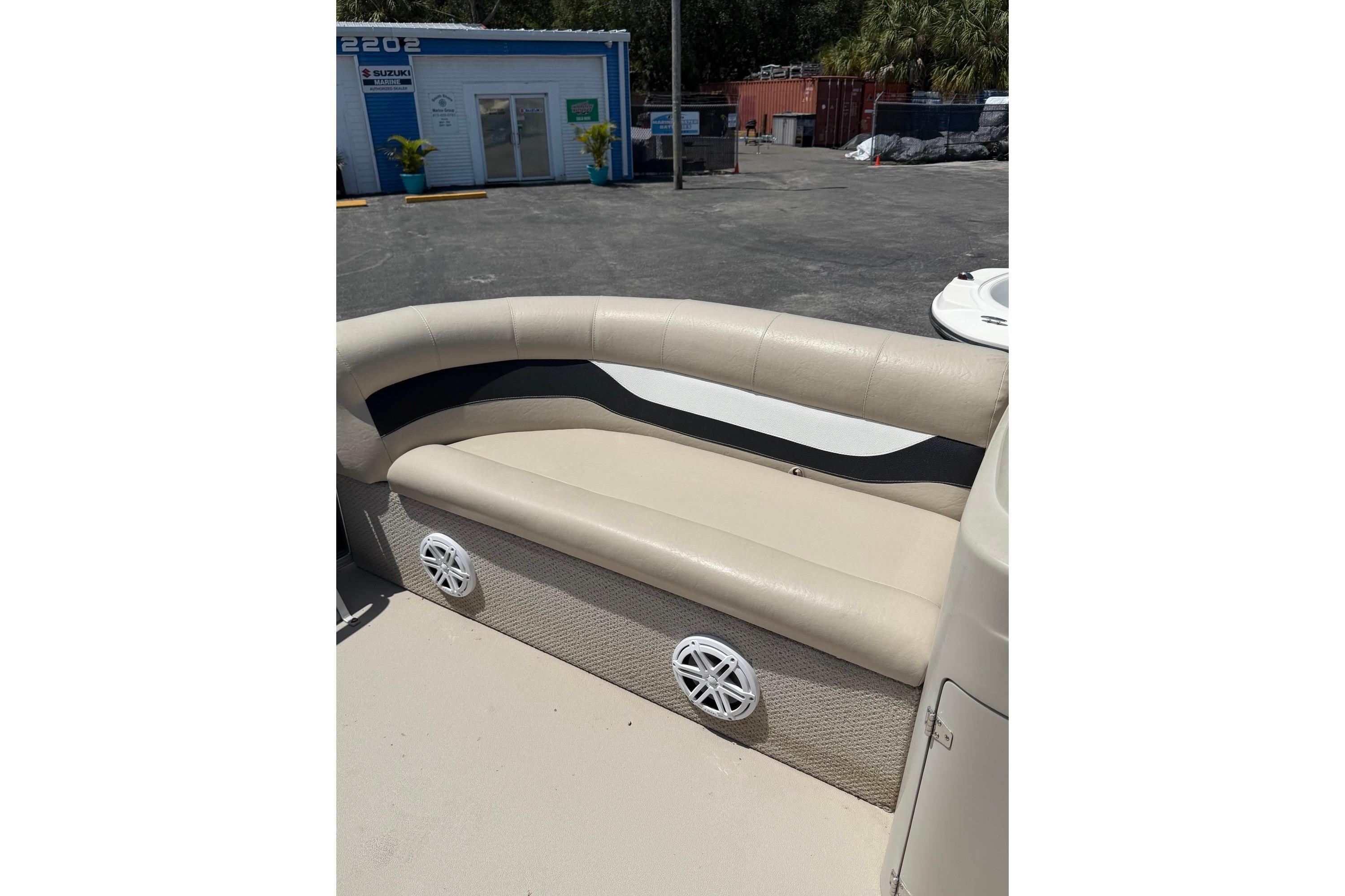 Beige seating area on a 2014 Avalon 1900 boat, with speakers underneath.