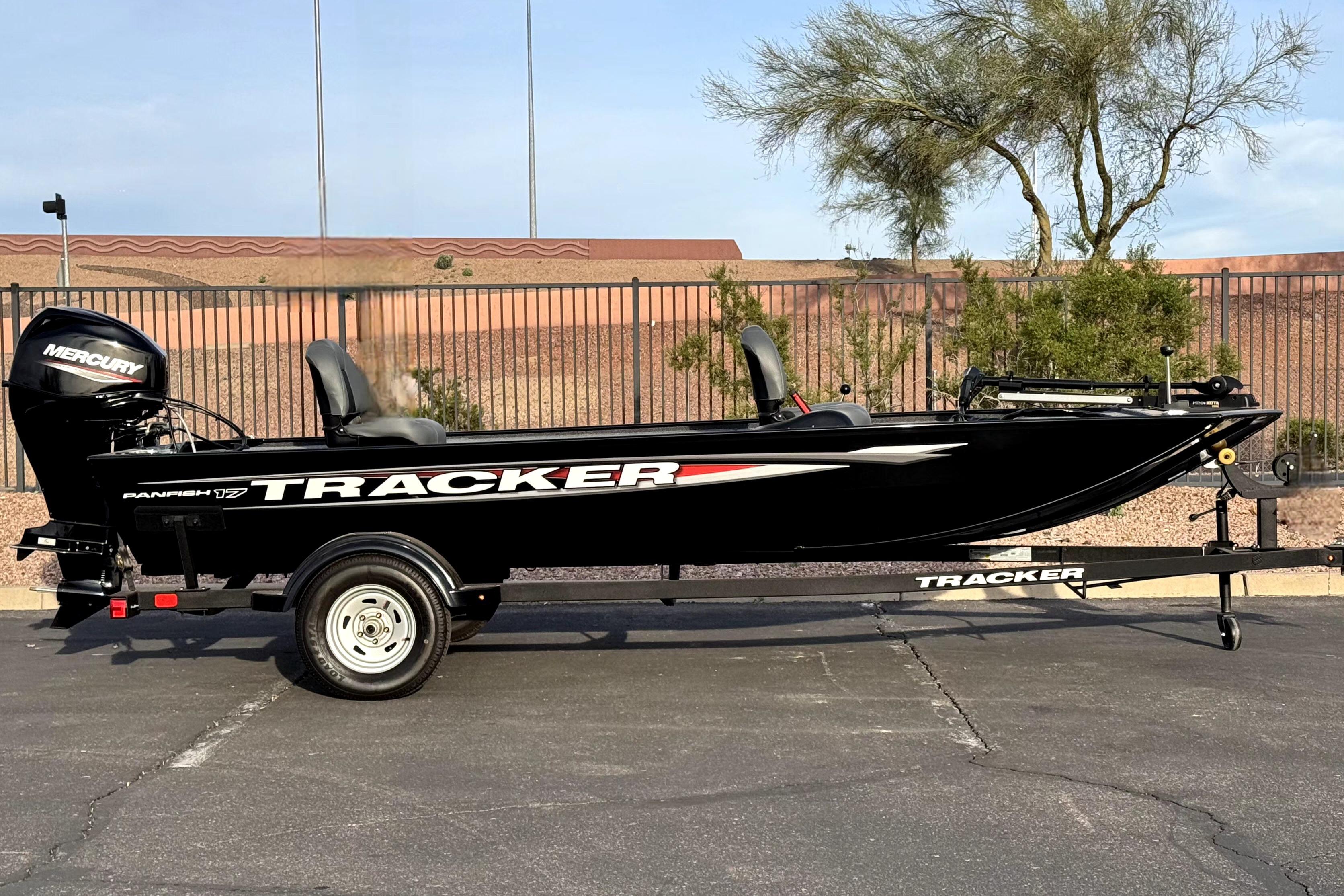 2025 Tracker Panfish 17 boat with Mercury engine on trailer, parked outdoors.