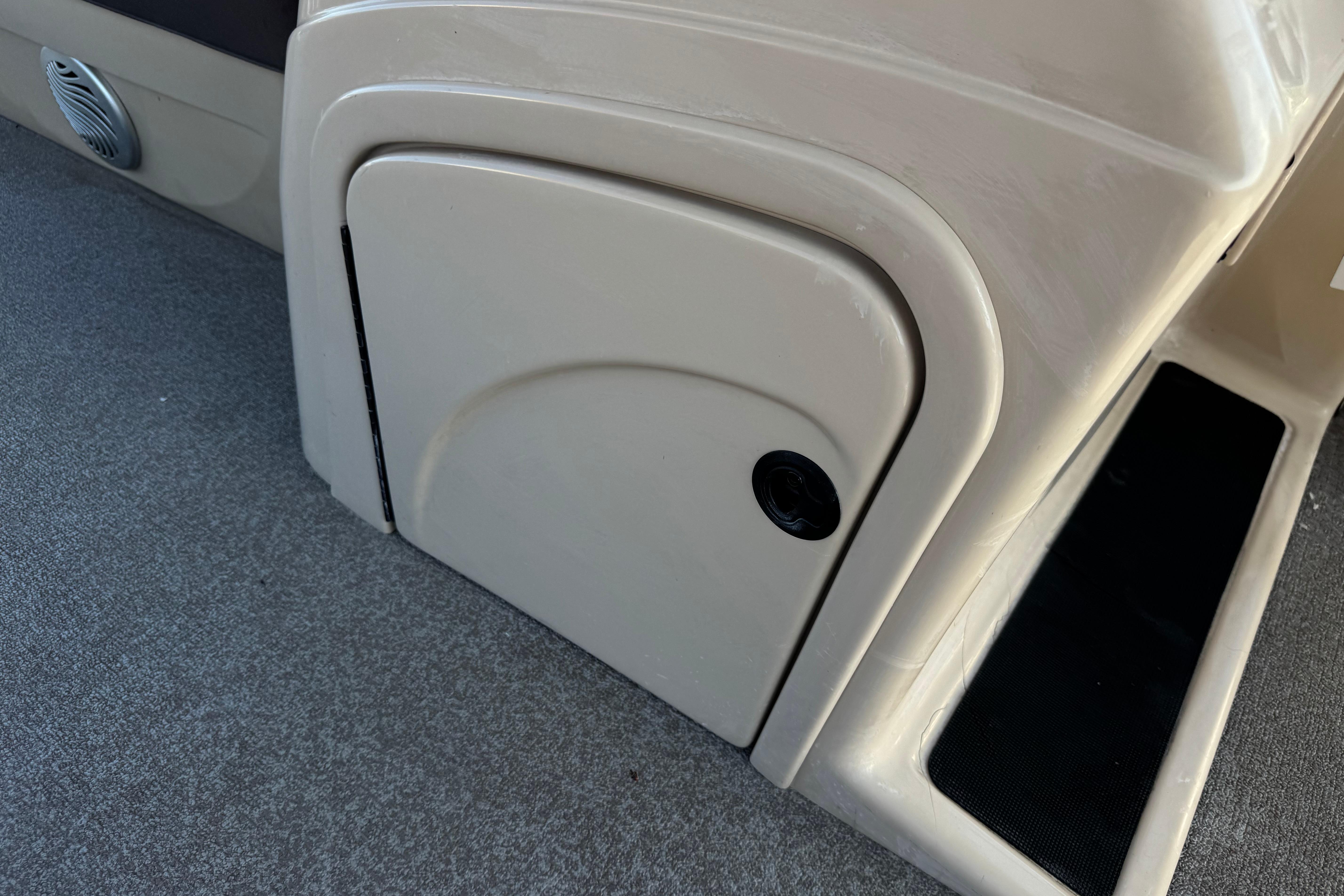 Storage compartment on a 2018 Sun Tracker SportFish 22 DLX boat interior.