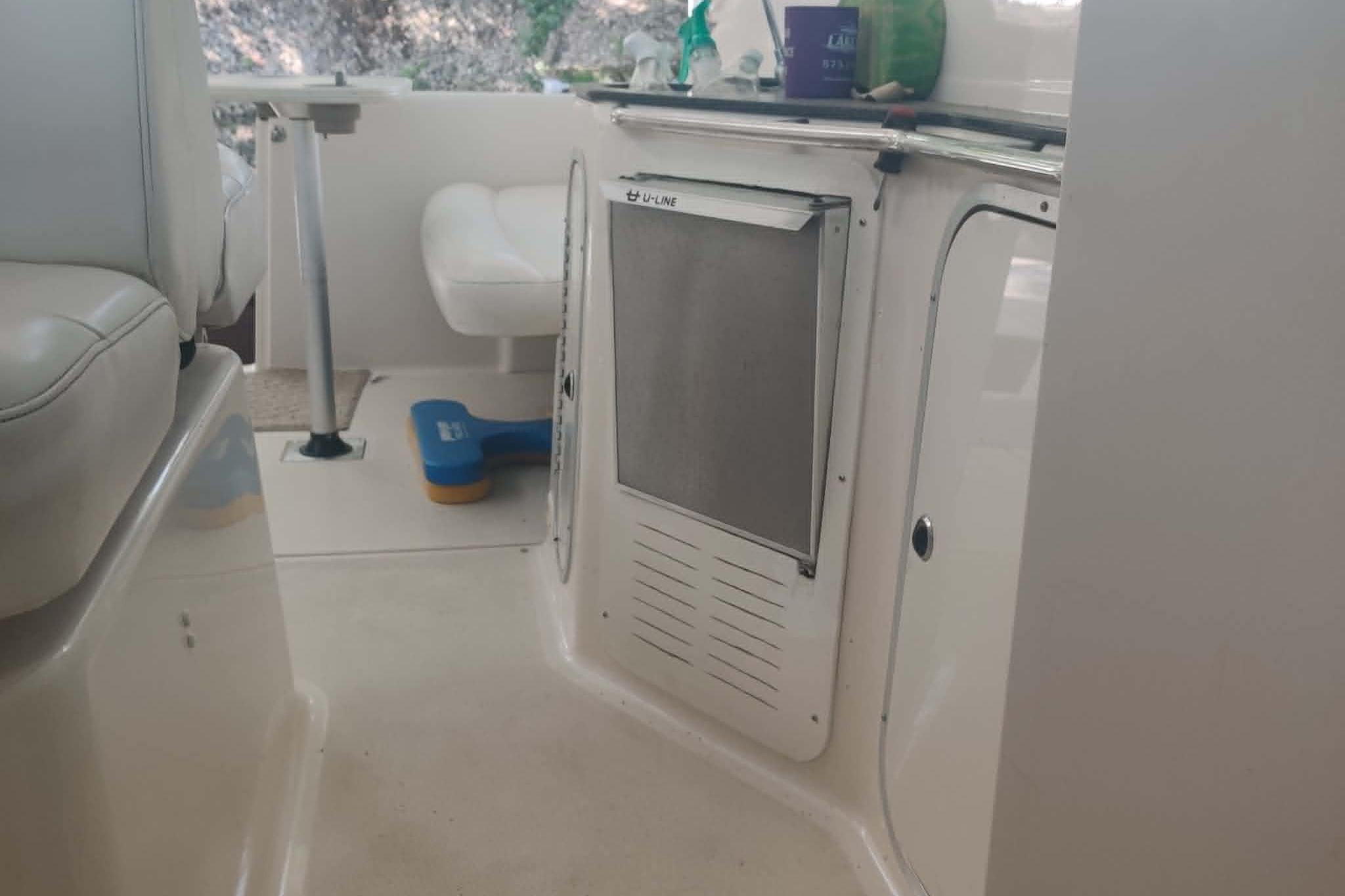 Interior of a 2001 Maxum 3300 SCR boat, featuring seating and storage areas.