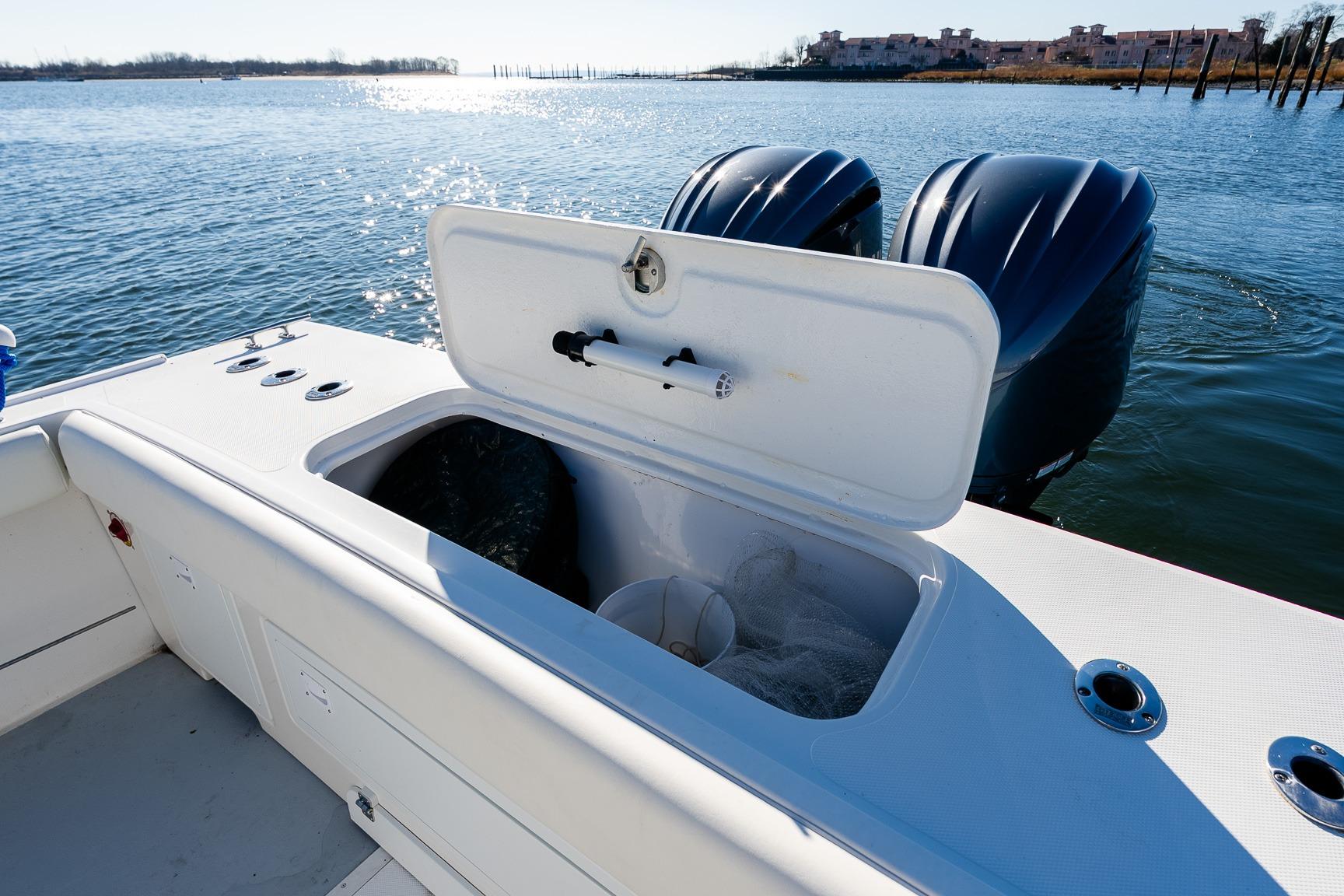 2024 Steiger Craft 31 Fisherman boat with open storage compartment and dual engines on water.