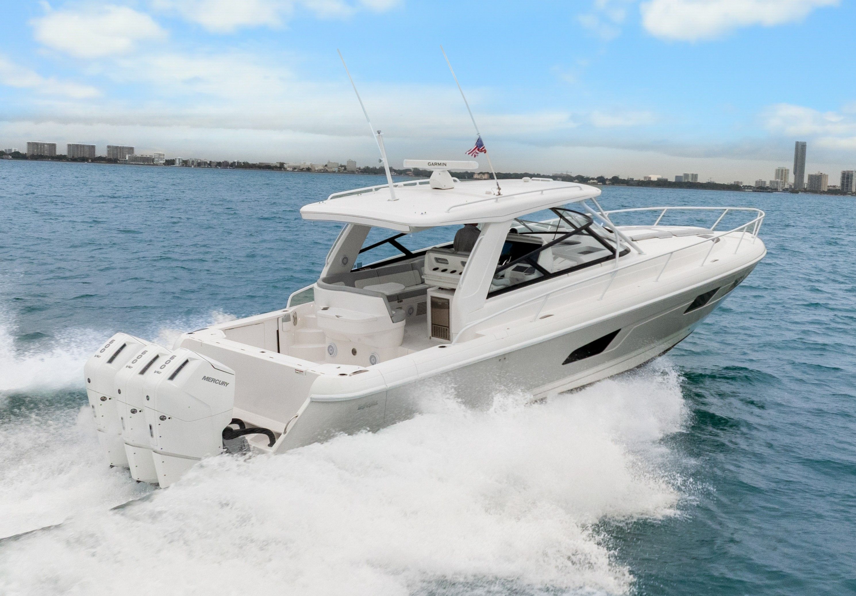 2024 Intrepid 477 Evolution boat on water, featuring triple Mercury engines.