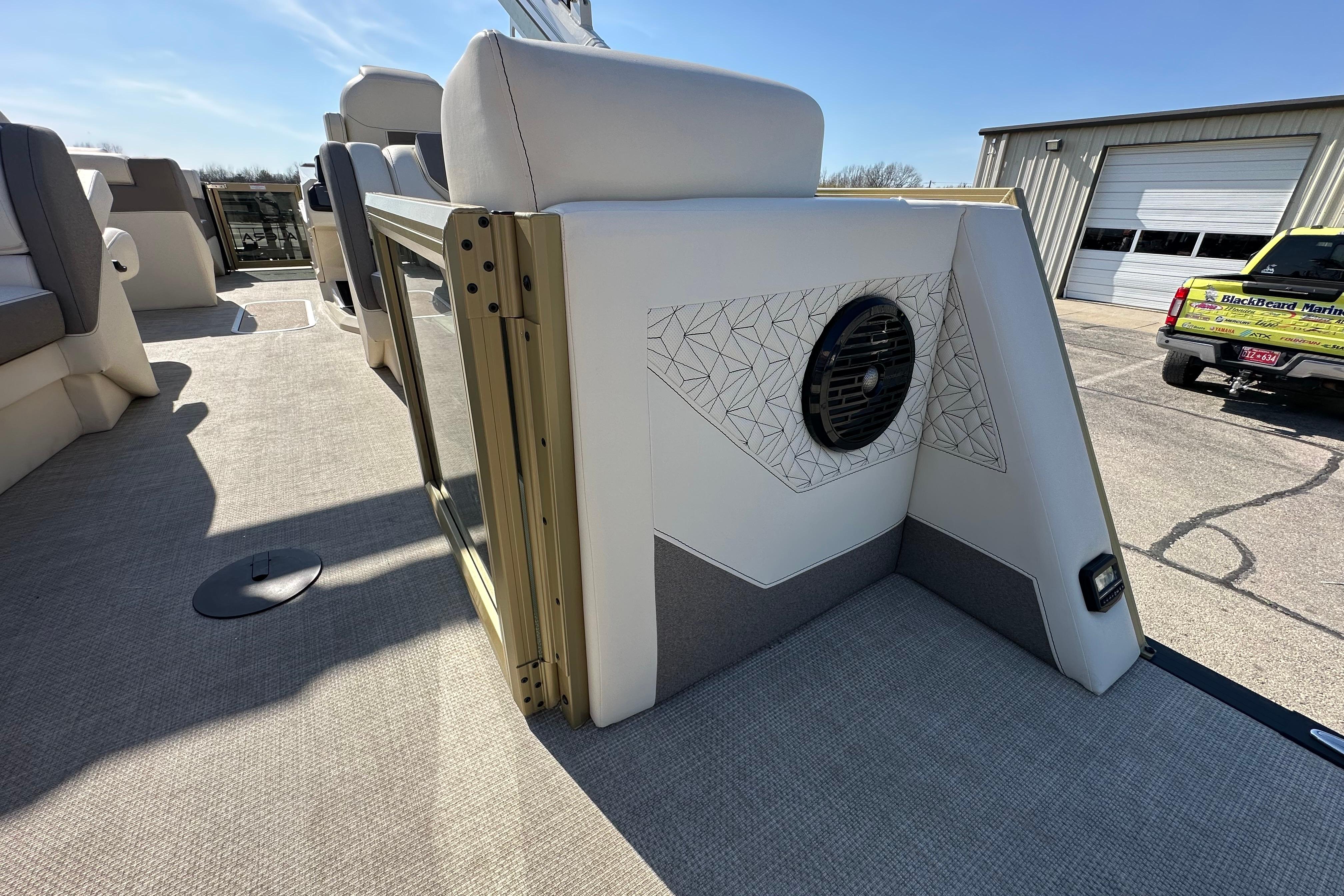Interior of 2026 Alera M23Q boat with modern seating and speaker system.
