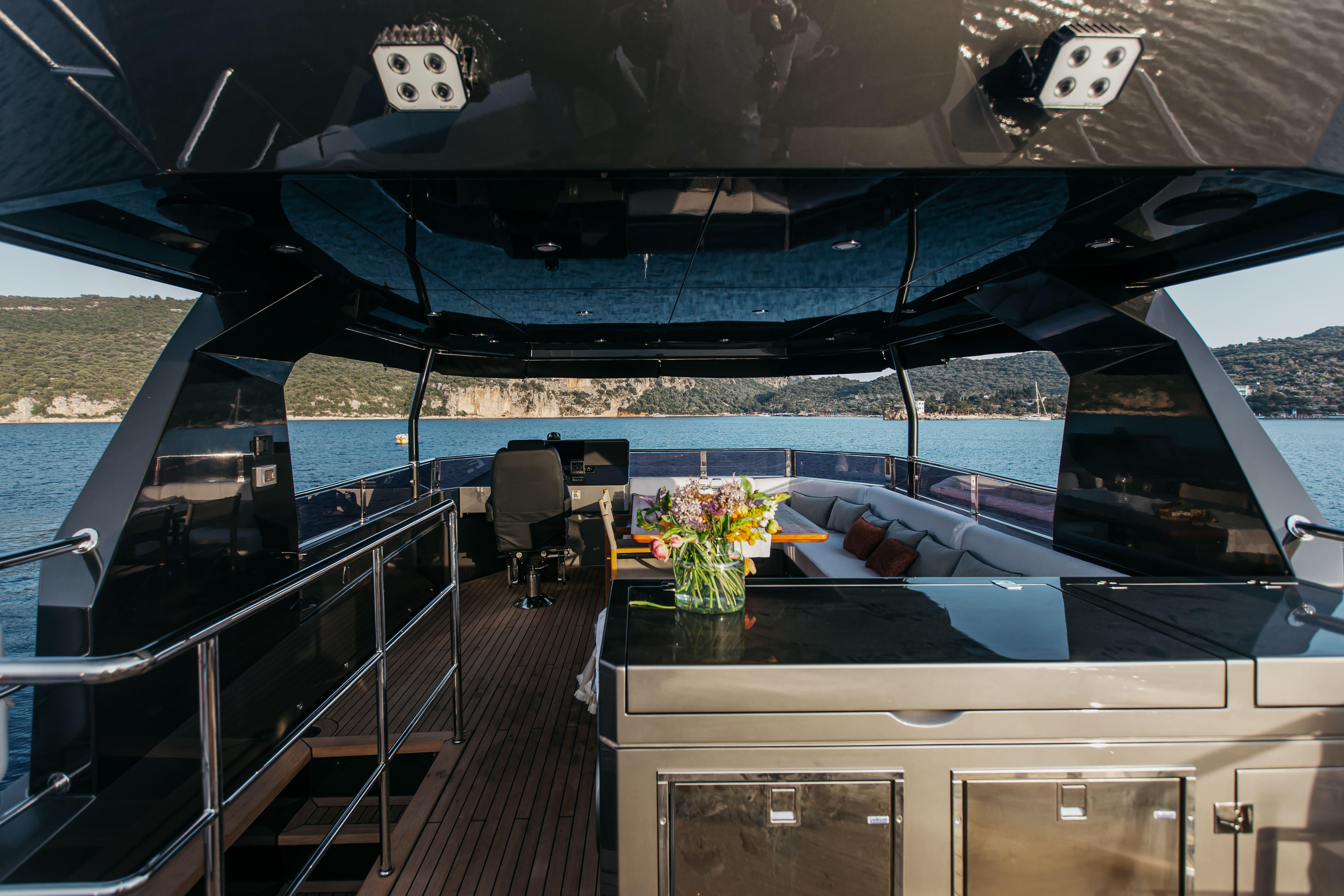 Luxurious 2022 Bering 70 Levanna yacht interior with seating and ocean view.