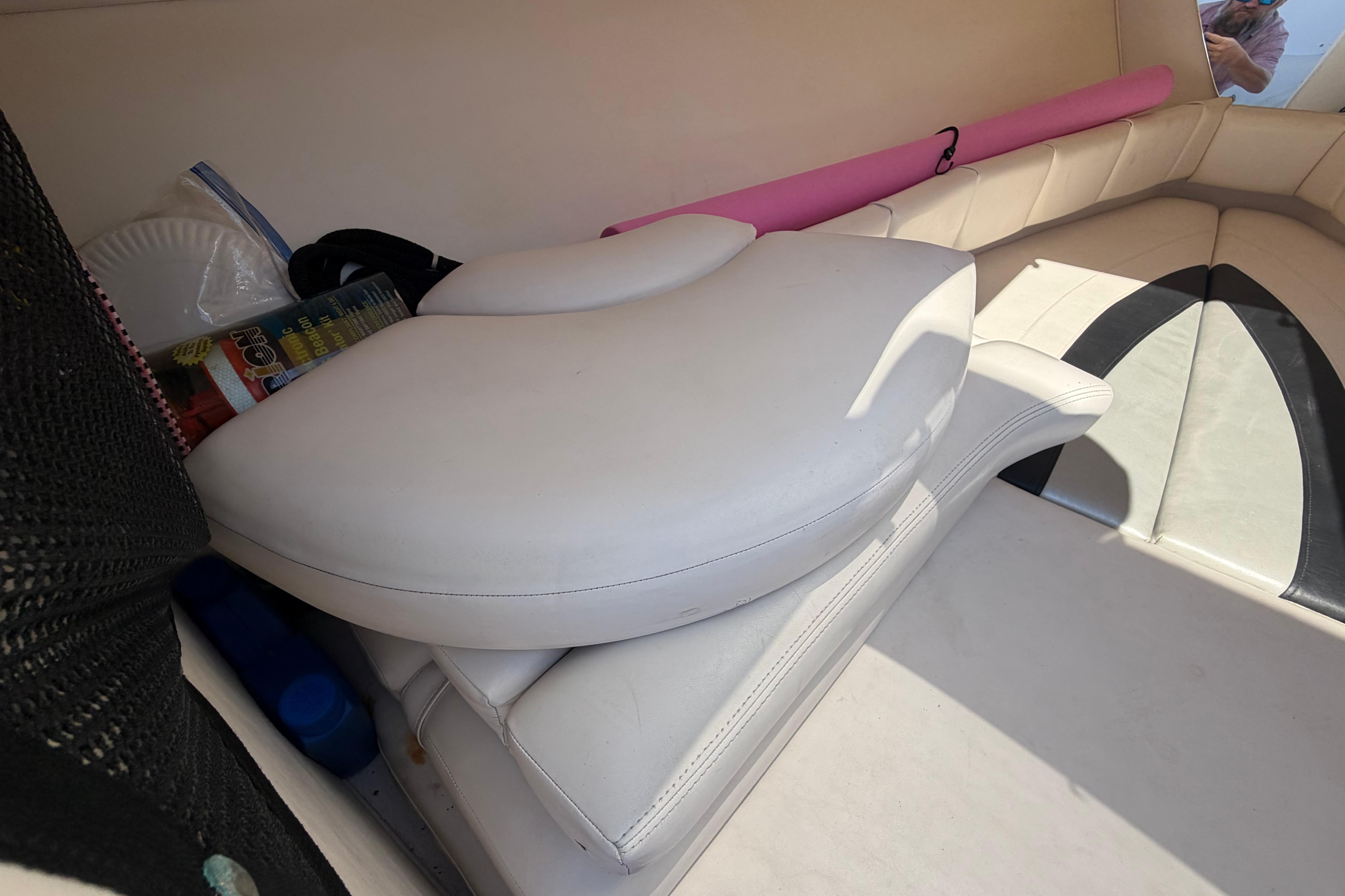 Interior of 2008 Donzi 35 ZF Cuddy with white seating and storage items.