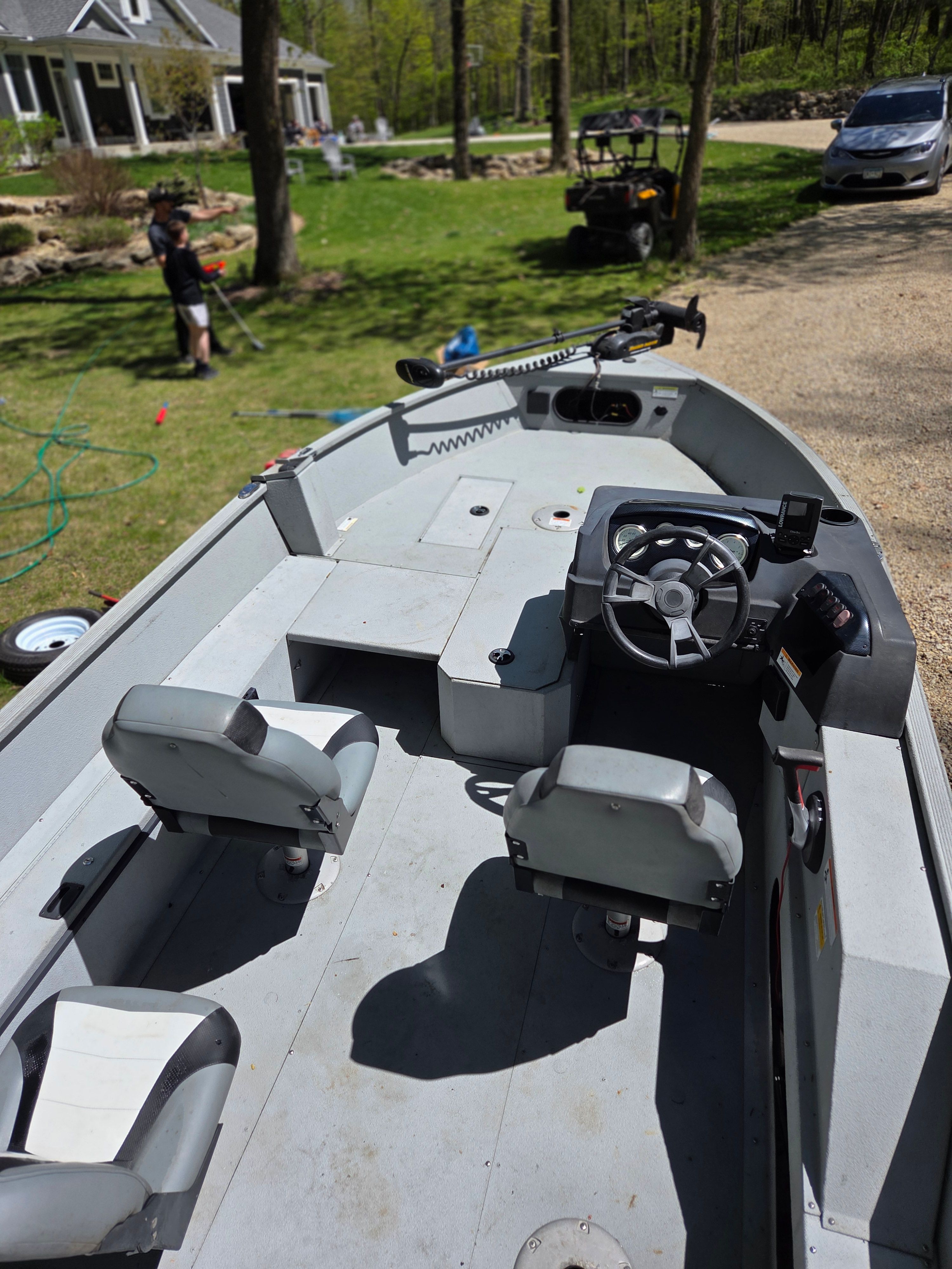 2015 Lowe Fishing Machine 165 Poly Camo boat parked in garden.