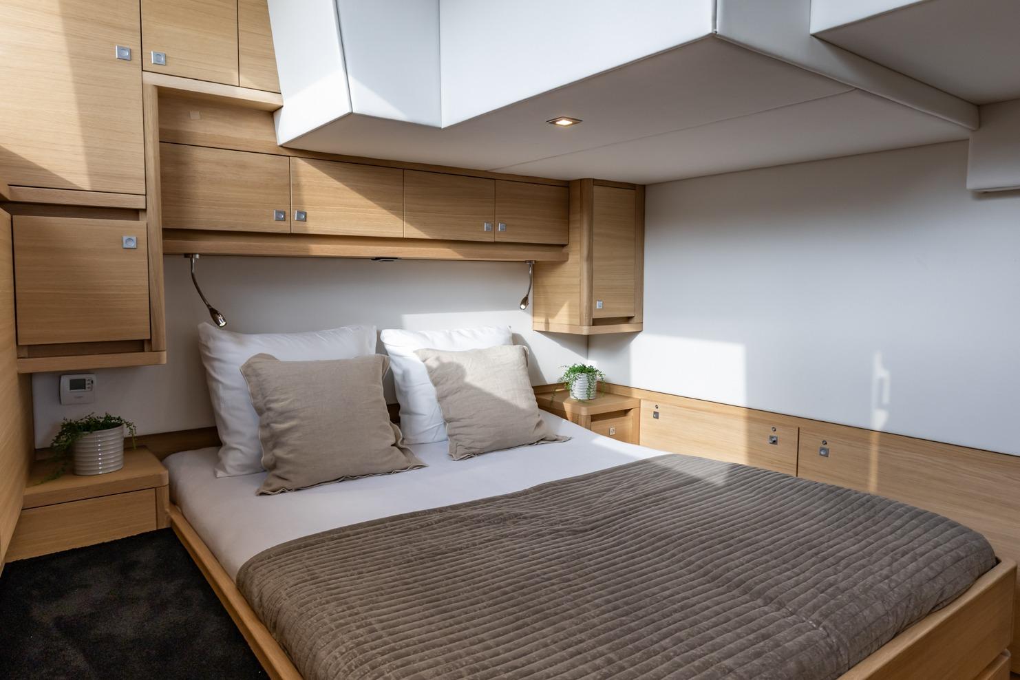 Luxurious bedroom interior of 2017 Steeler Panorama FF 53 yacht with modern wood finish.