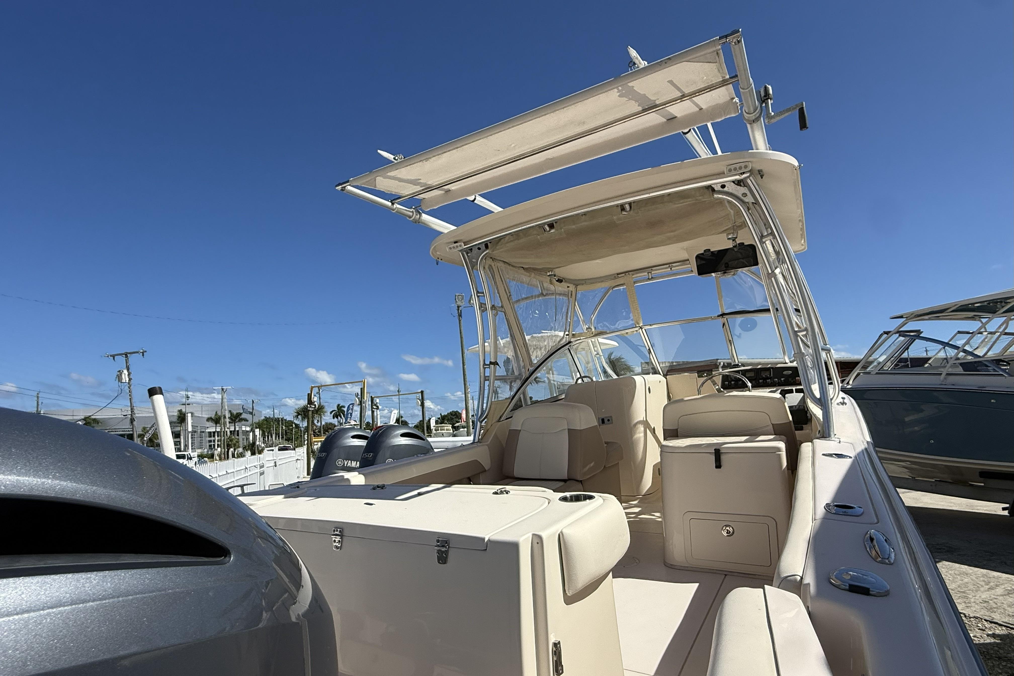 2014 Grady-White Freedom 275 boat with dual Yamaha engines, docked under clear blue sky.