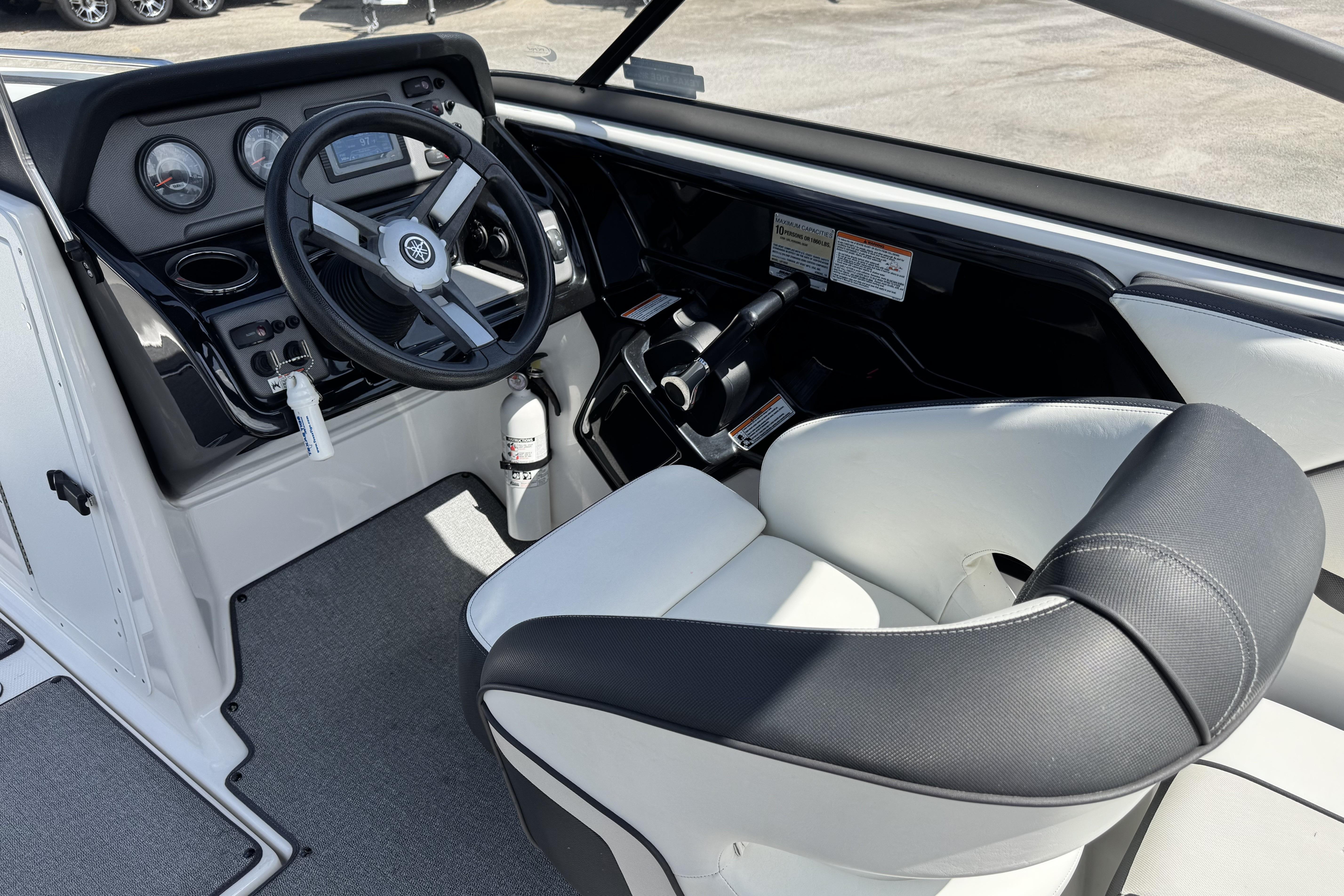 2018 Yamaha AR210 boat cockpit with steering wheel and control panel.