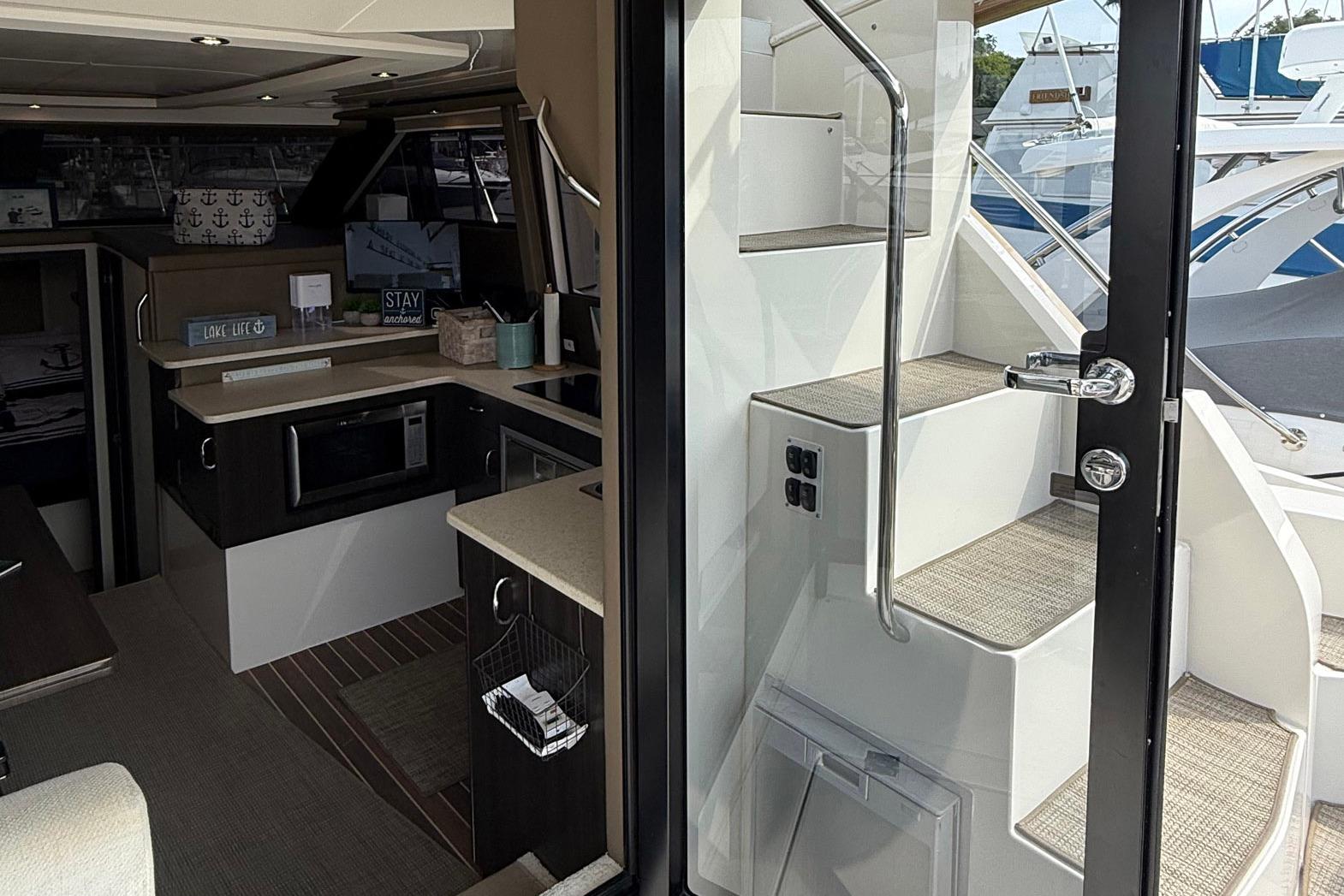 Interior view of 2013 Carver C34 yacht, featuring modern kitchen and staircase.