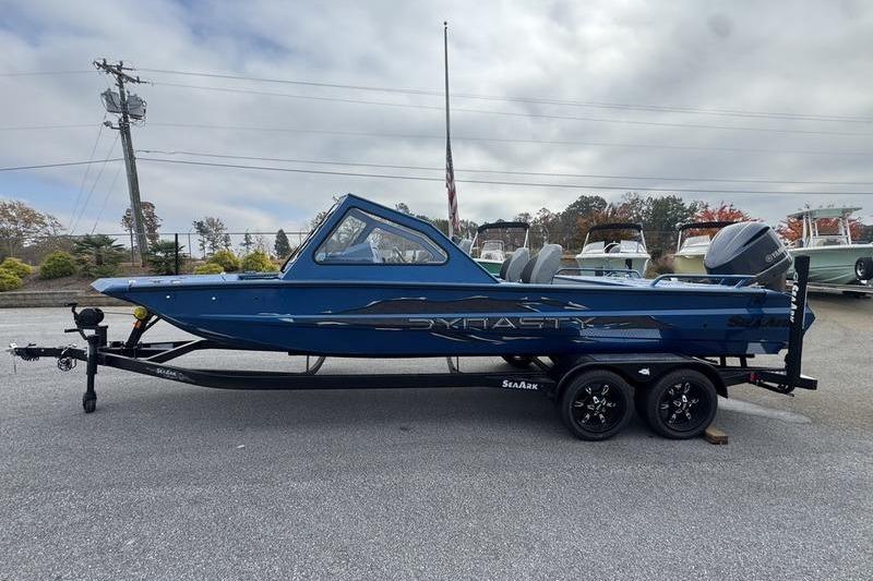 2026 SeaArk Dynasty 2.0 boat on trailer, blue exterior, parked outdoors.