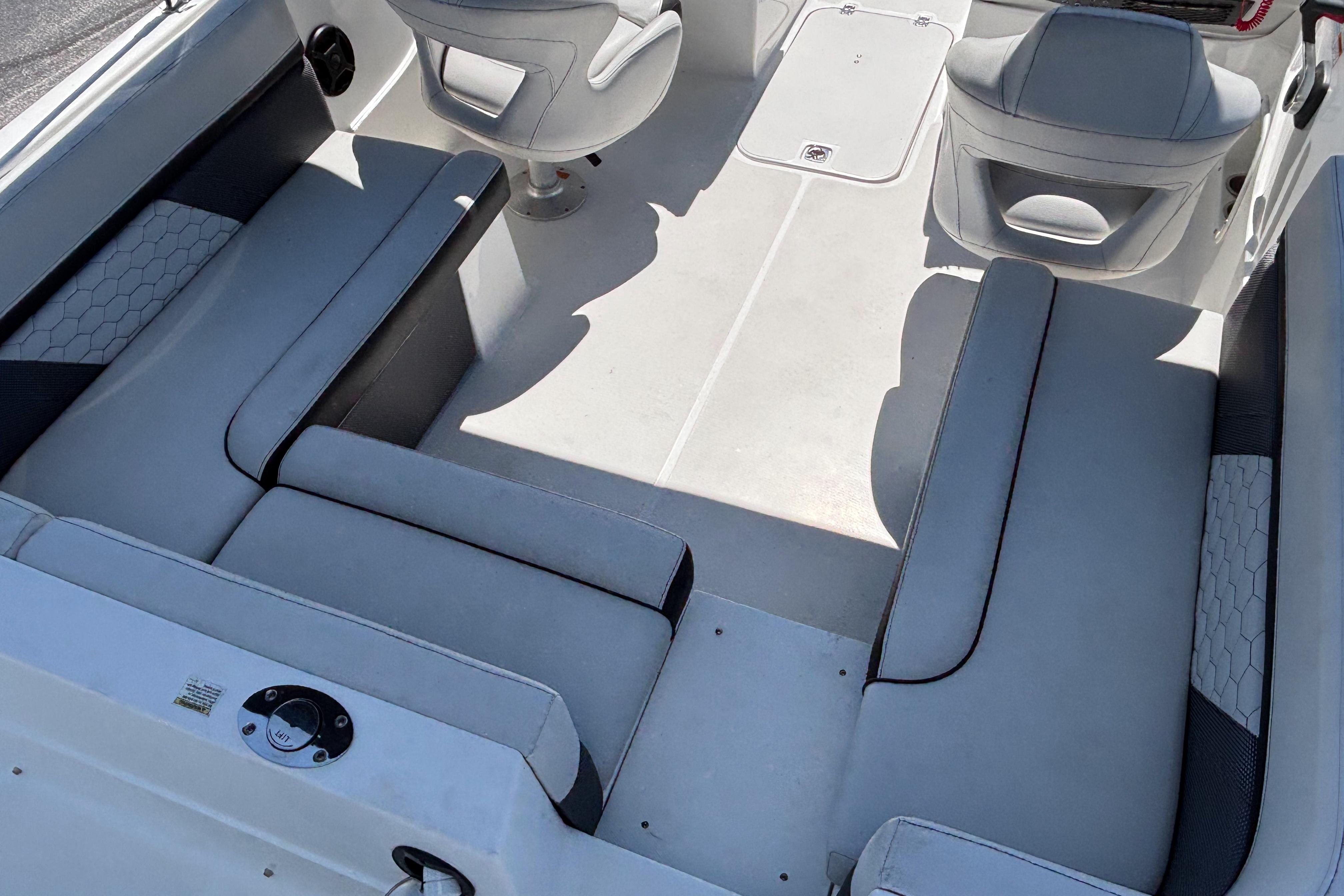 2019 Hurricane Sundeck Sport 218 OB boat interior with gray seating and white flooring.