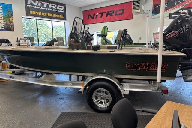 2025 Mako 18 Pro Skiff Backwater Edition boat displayed in showroom on trailer.