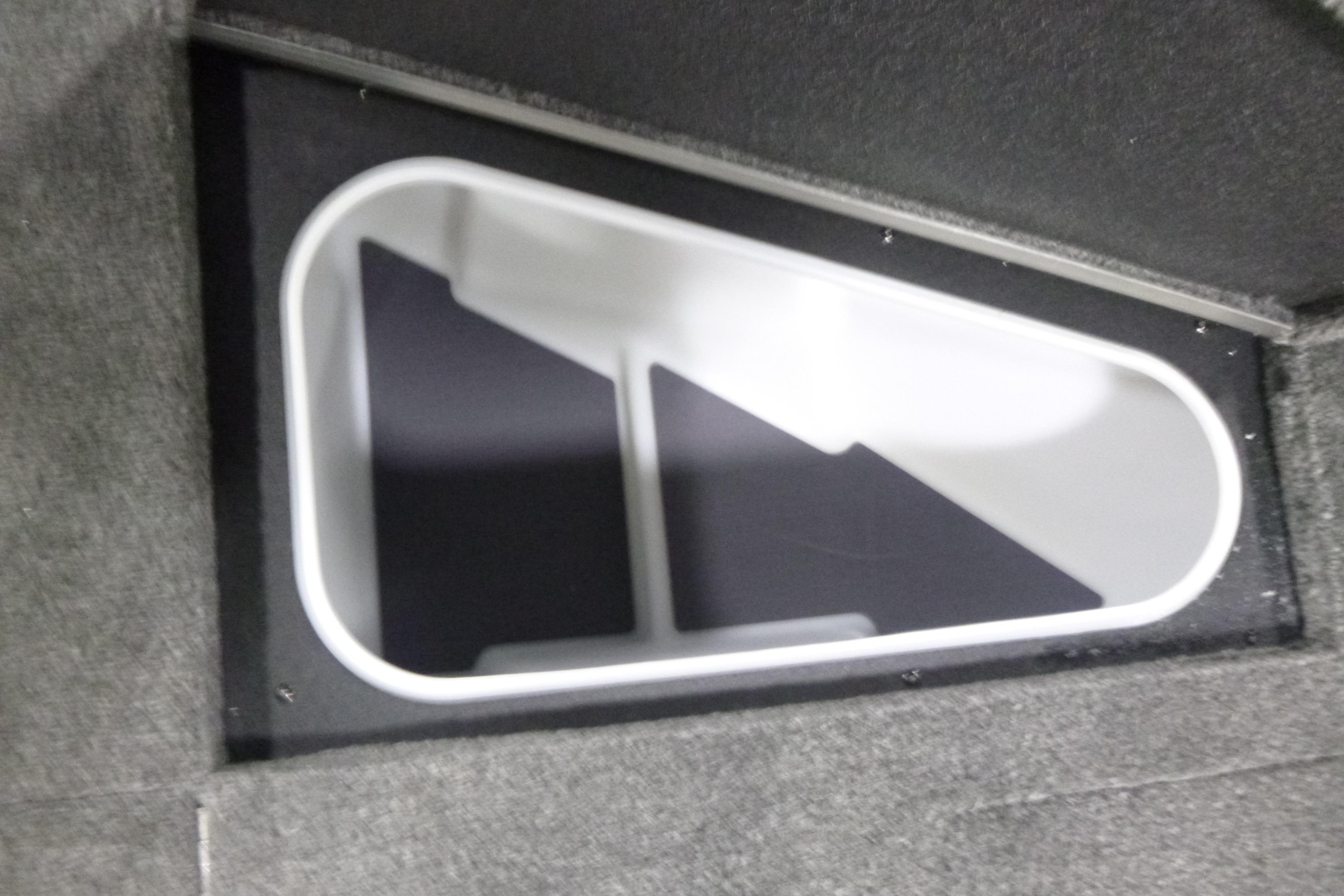 2026 Alumacraft Trophy 205X Sport storage compartment with white interior and gray carpeted exterior.