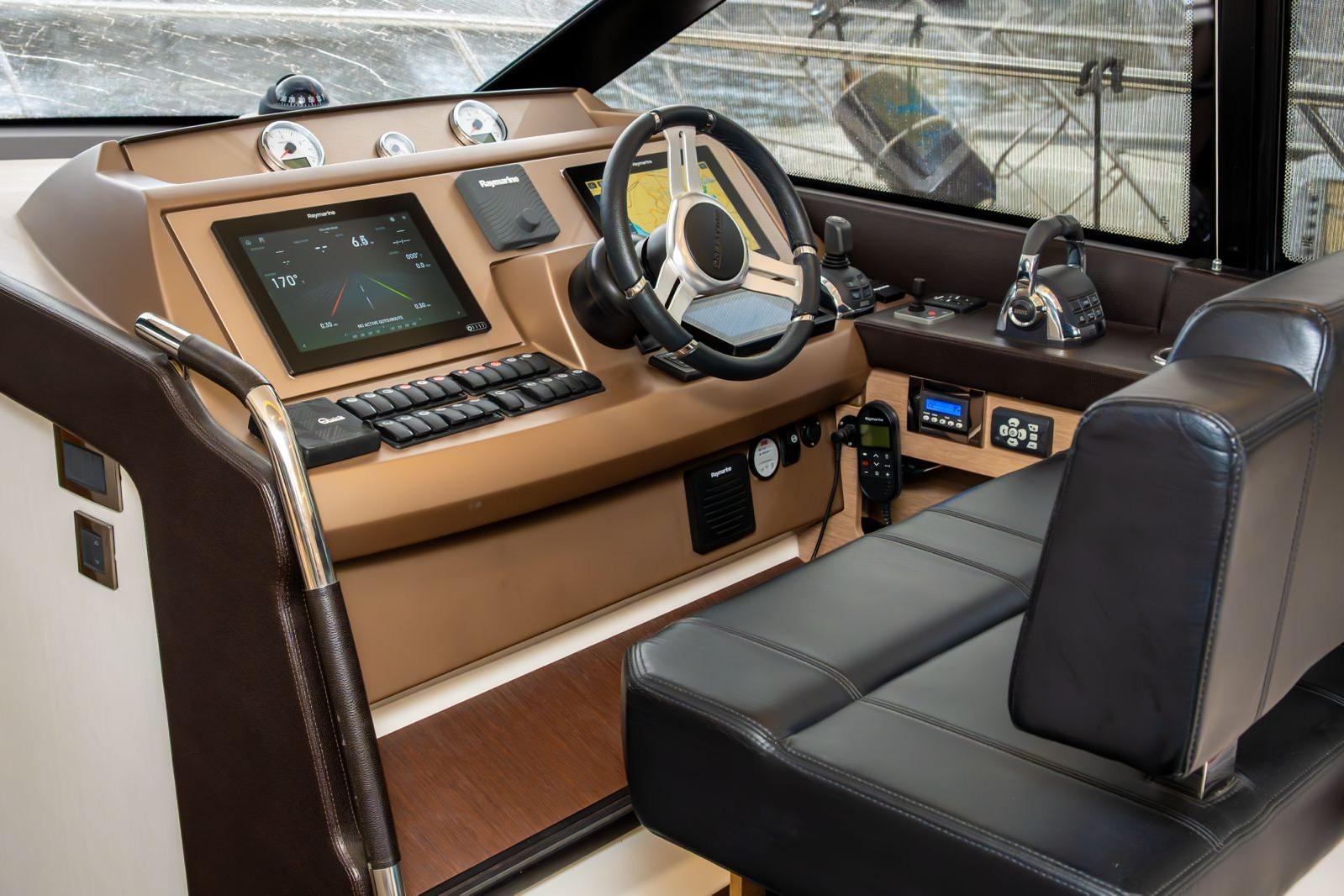 Helm of 2019 Prestige 500 yacht with modern navigation controls and leather seating.