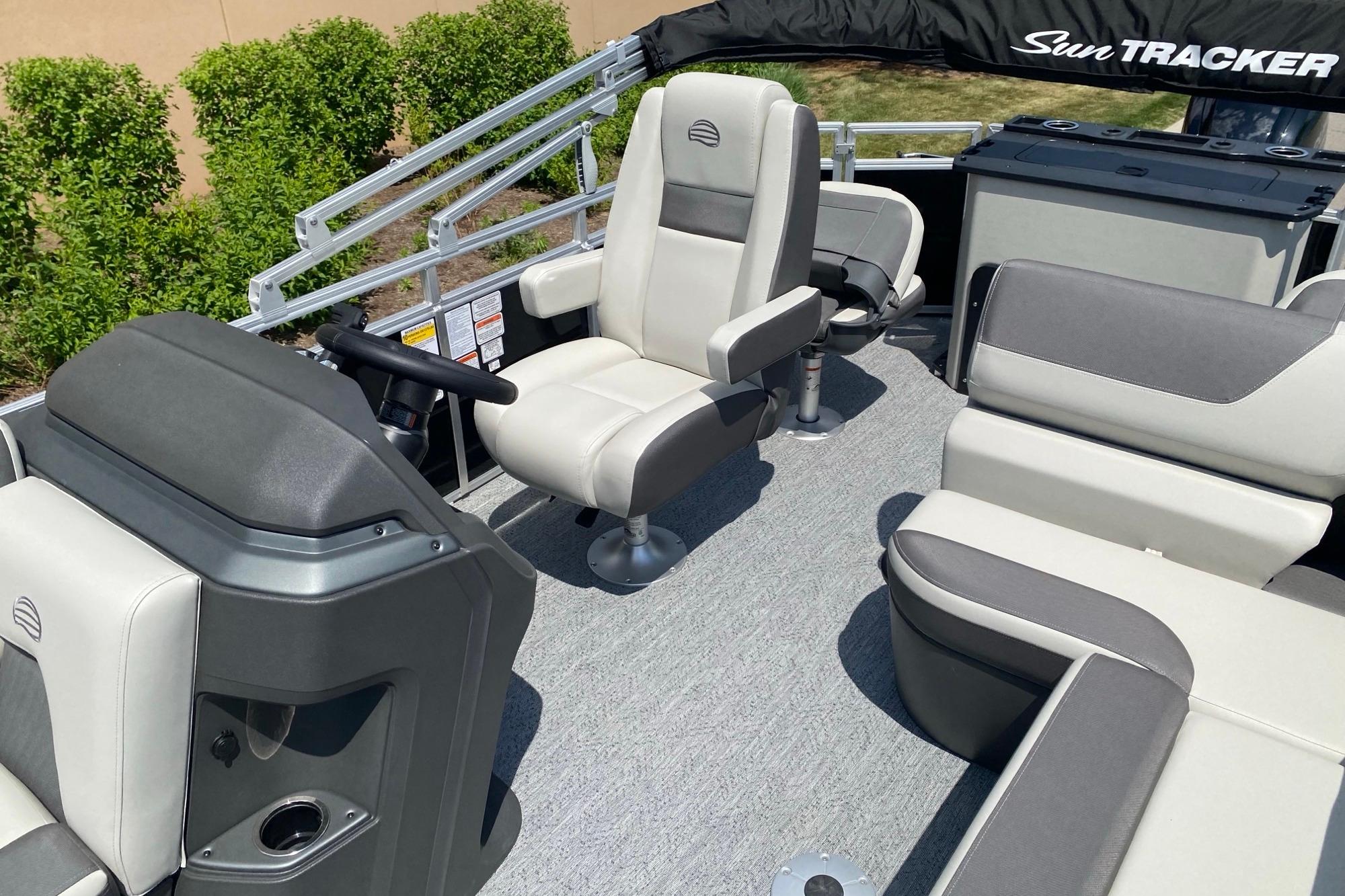 2026 Sun Tracker Fishin' Barge 20 DLX interior with comfortable seating and steering console.
